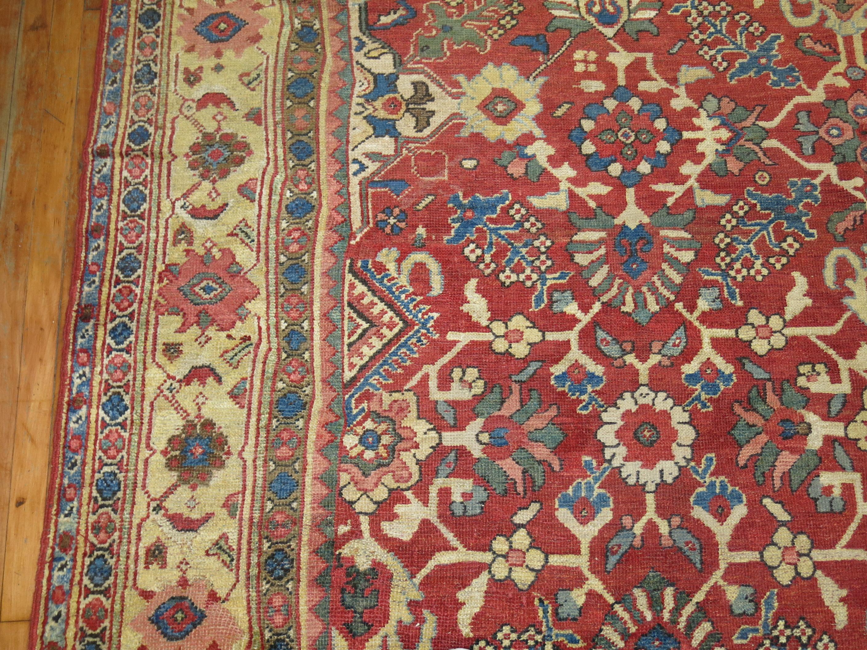 Room size Persian antique Mahal room size rug featuring an all-over repetitive design on a red field and beige/ivory border.

9'6'' x 13'9''
 