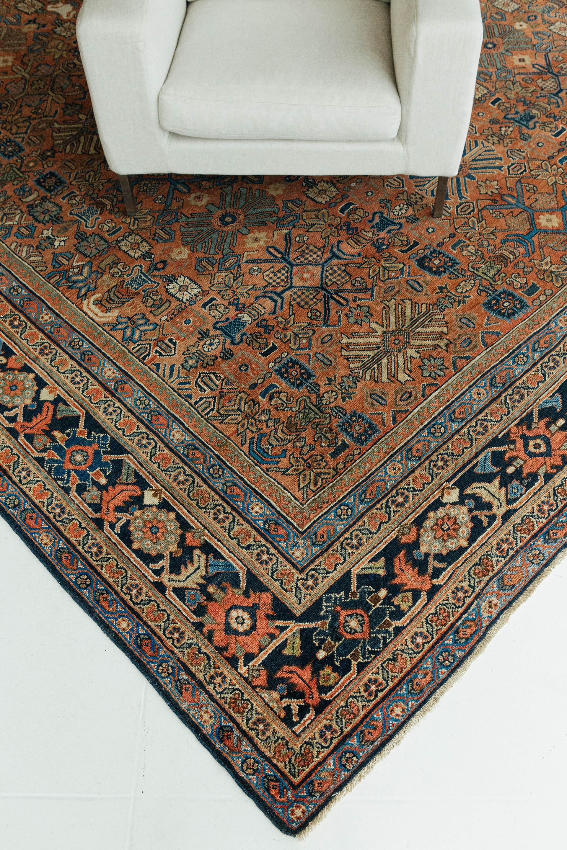 Antique Mahal features a rust field with olive, ivory, deep indigo and brilliant cerulean accents. All-over design clambering with stylized floral and geometric motifs of varying scale in a soft grid formation. Borders feature finely rendered