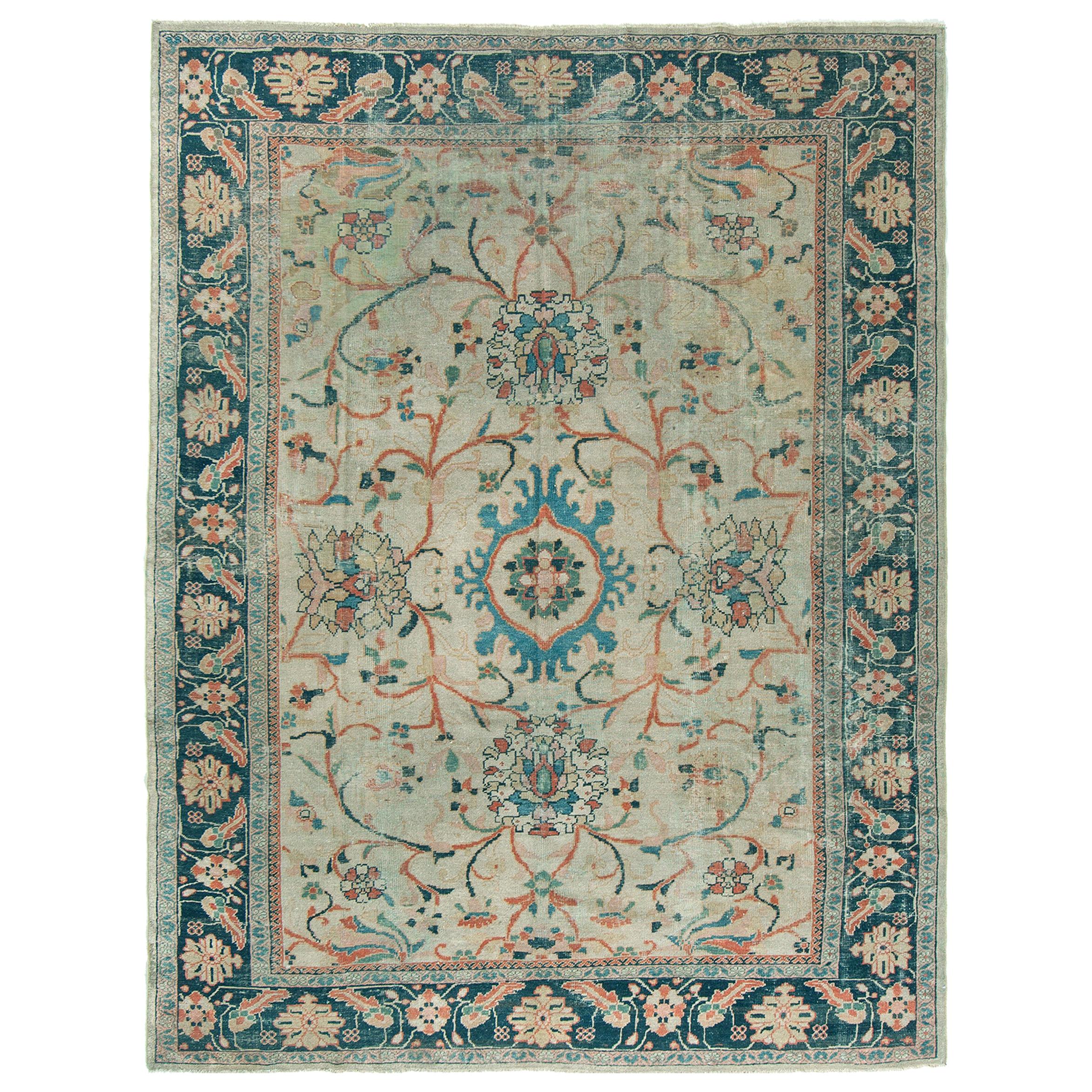 Characterized by an appealing classical composition, this antique Mahal carpet is a charming and exciting example. A series of ornate borders frames the piece, with floral patterns being dominant. Within the field, an elegant and classical all-over