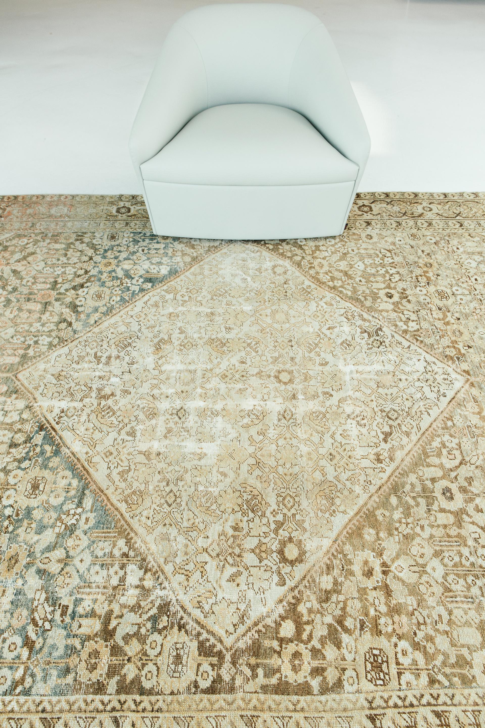 Soft tan and umber abrash toned pile are offset by fruity pinks and earthy indigos in this perfectly weathered antique Mahal. While etched passages reveal the touch of time, the geometry of rug’s medallion, field, cornerpieces and border areas
