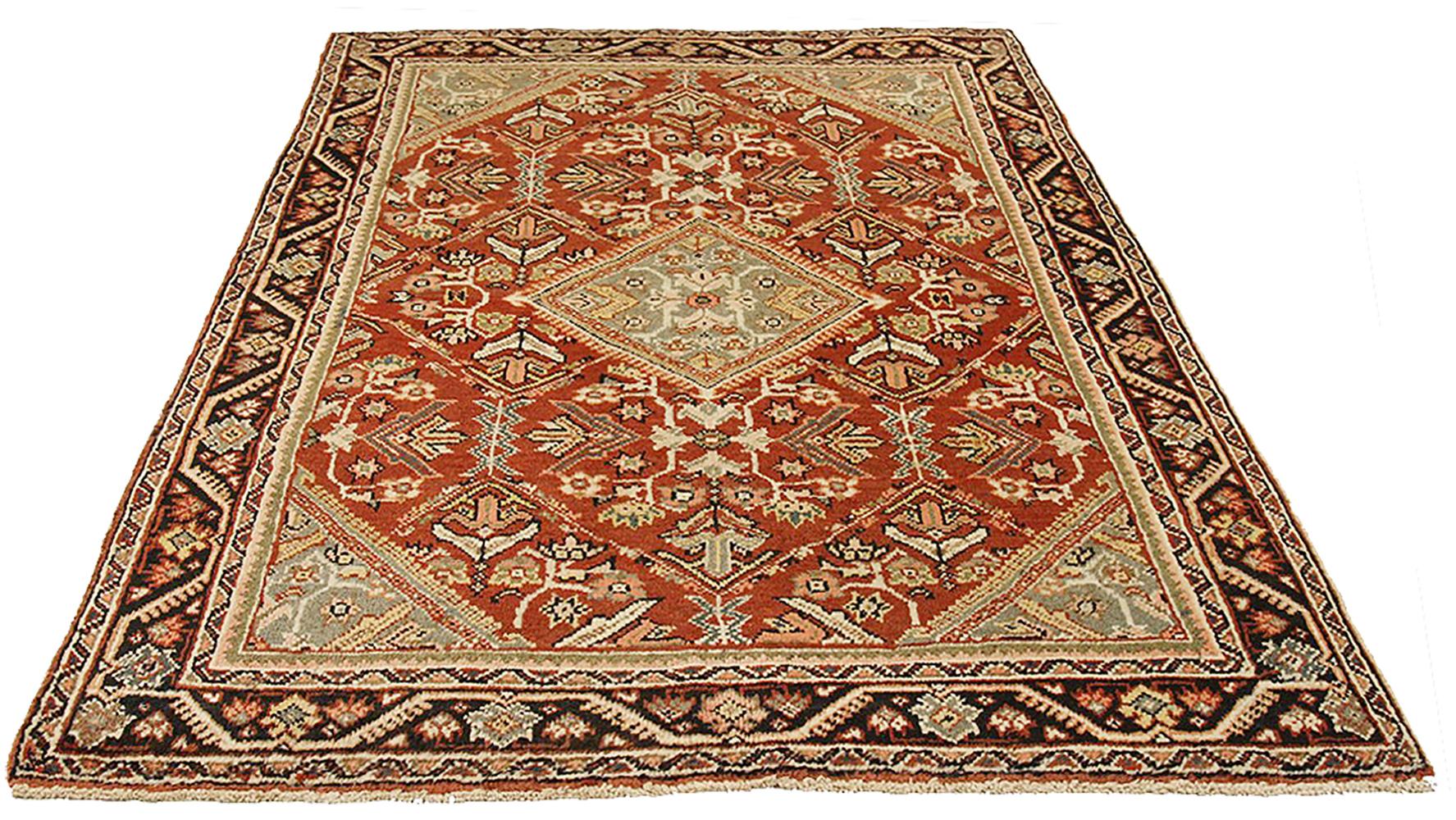 Antique Persian rug handwoven from the finest sheep’s wool and colored with all-natural vegetable dyes that are safe for humans and pets. It’s a traditional Mahal design featuring floral details in beige and gray over a red field. It’s a lovely