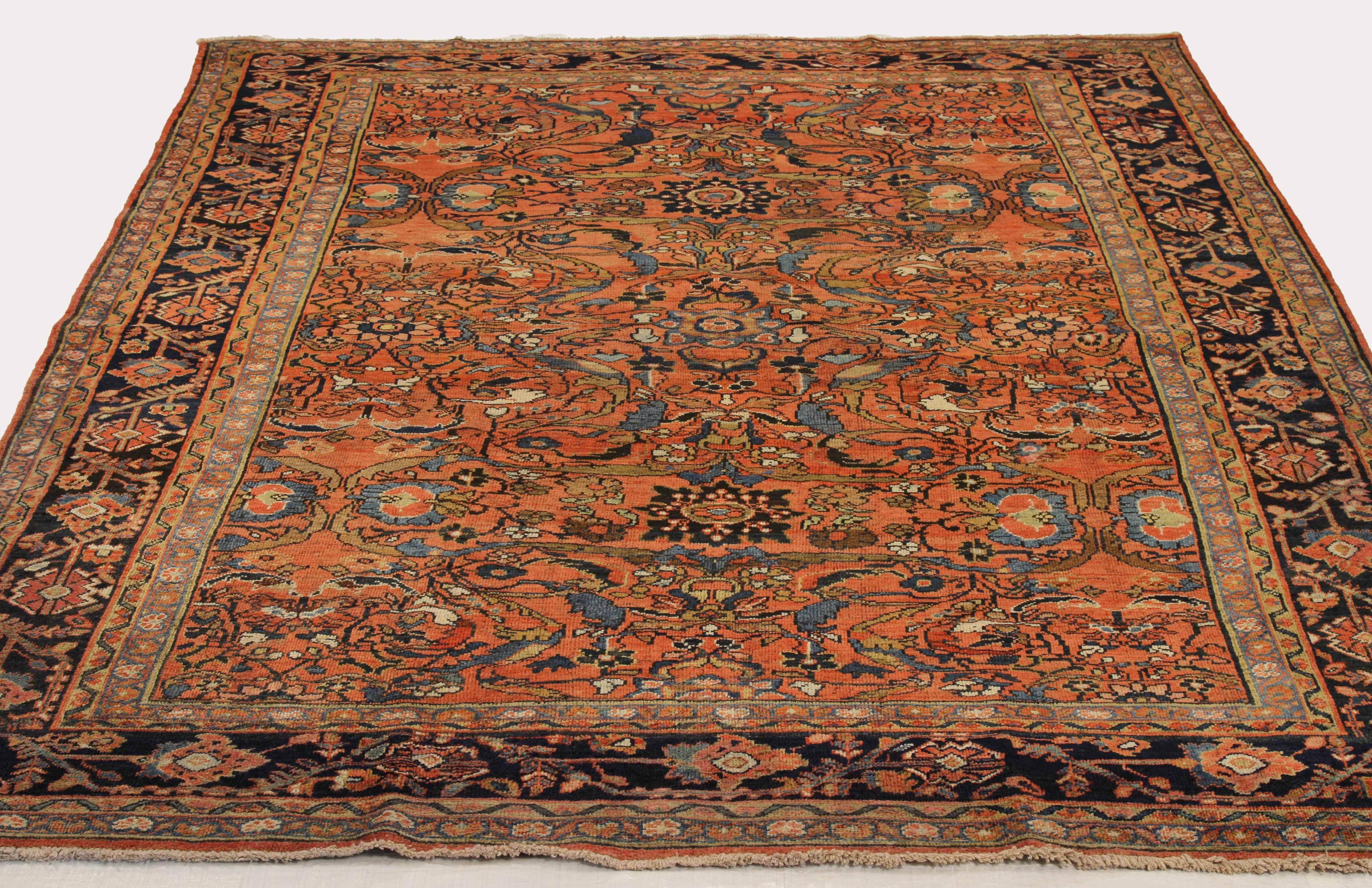 Antique Persian rug handwoven from the finest sheep’s wool and colored with all-natural vegetable dyes that are safe for humans and pets. It’s a traditional Mahal design featuring floral details in green and blue over a red center field. It’s a