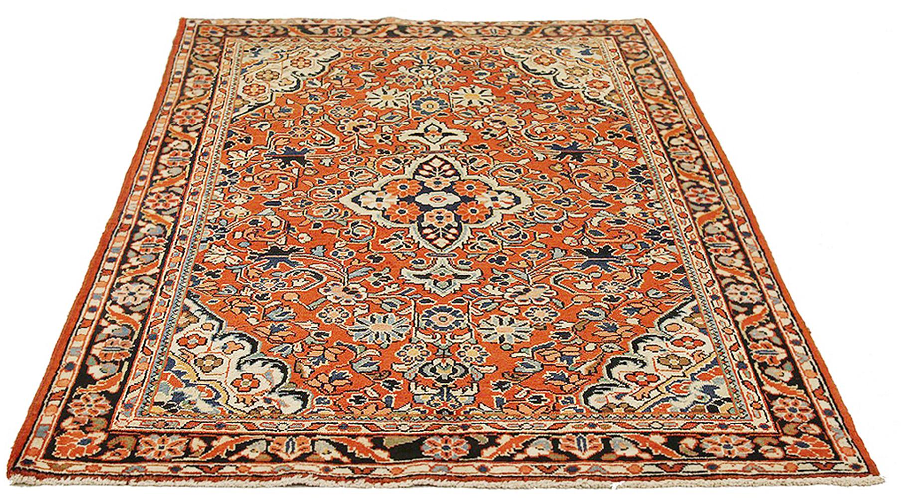 Antique Persian rug handwoven from the finest sheep’s wool and colored with all-natural vegetable dyes that are safe for humans and pets. It’s a traditional Mahal design featuring floral details in blue and white over a rust field. It’s a lovely