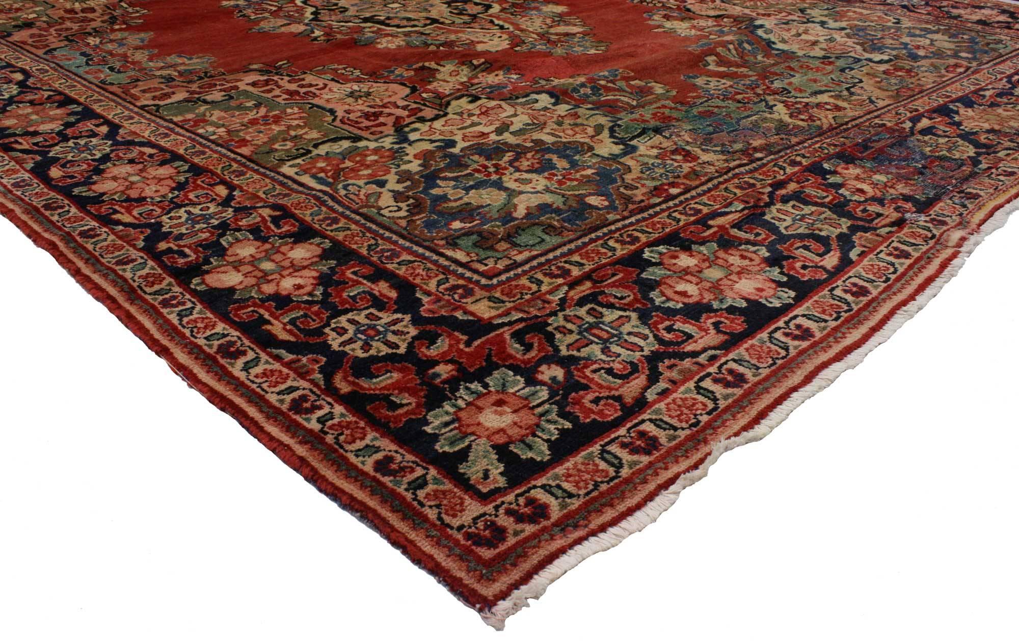 74414 Antique Persian Mahal Rug with English Country Cottage Style 09'00 X 11'05. Boasting a floral bounty in a range of warm hues, this antique Persian Mahal rug is a delightful example of English Country Cottage style. At the center of the