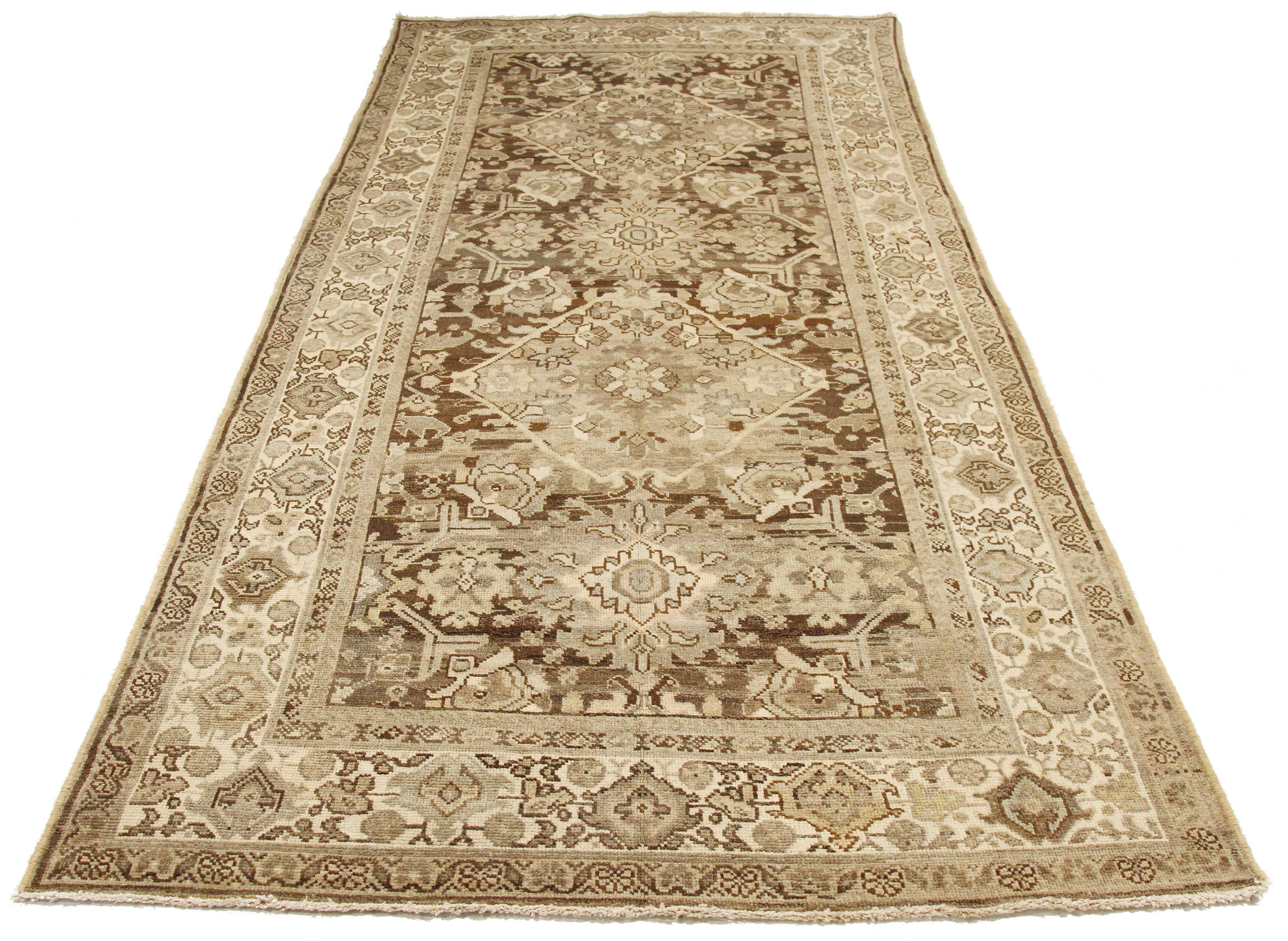 Antique Persian rug handwoven from the finest sheep’s wool and colored with all-natural vegetable dyes that are safe for humans and pets. It’s a traditional Mahal design featuring botanical details in ivory and brown. It’s a lovely piece to showcase