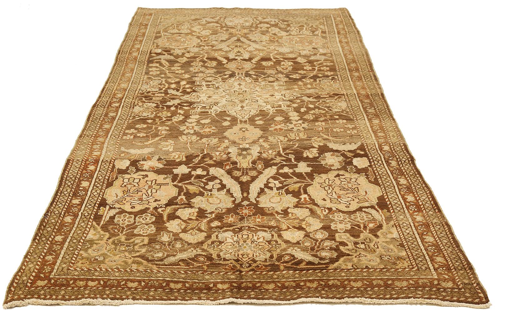 Antique Persian rug handwoven from the finest sheep’s wool and colored with all-natural vegetable dyes that are safe for humans and pets. It’s a traditional Mahal design featuring floral details in gray and ivory over a brown field. It’s a lovely