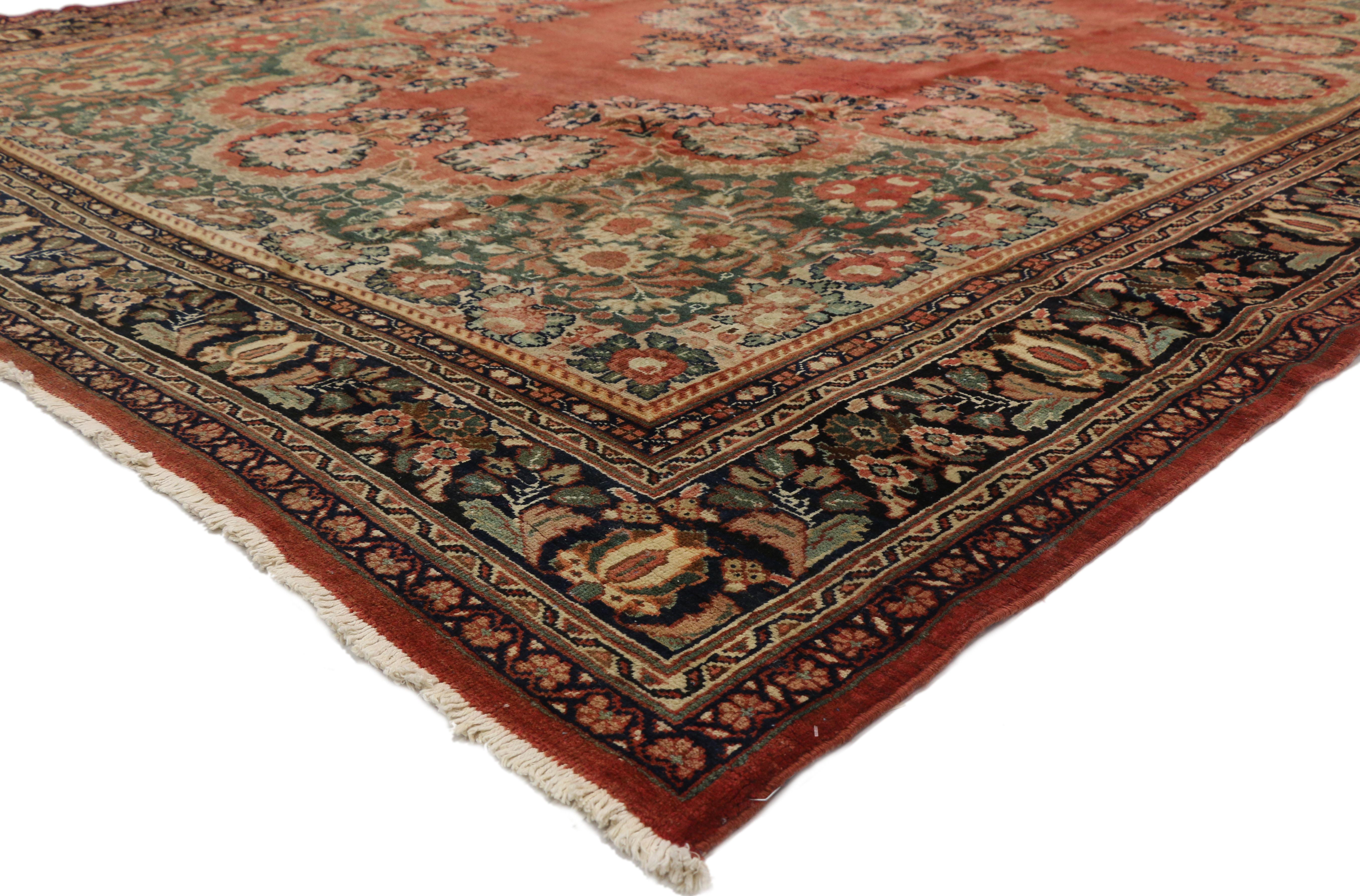 73370 Antique Persian Mahal Rug with Rustic English Country Style. Boasting a floral bounty in a range of warm hues, this hand-knotted wool antique Persian Mahal rug is a delightful example of rustic English Country style. At the center of the