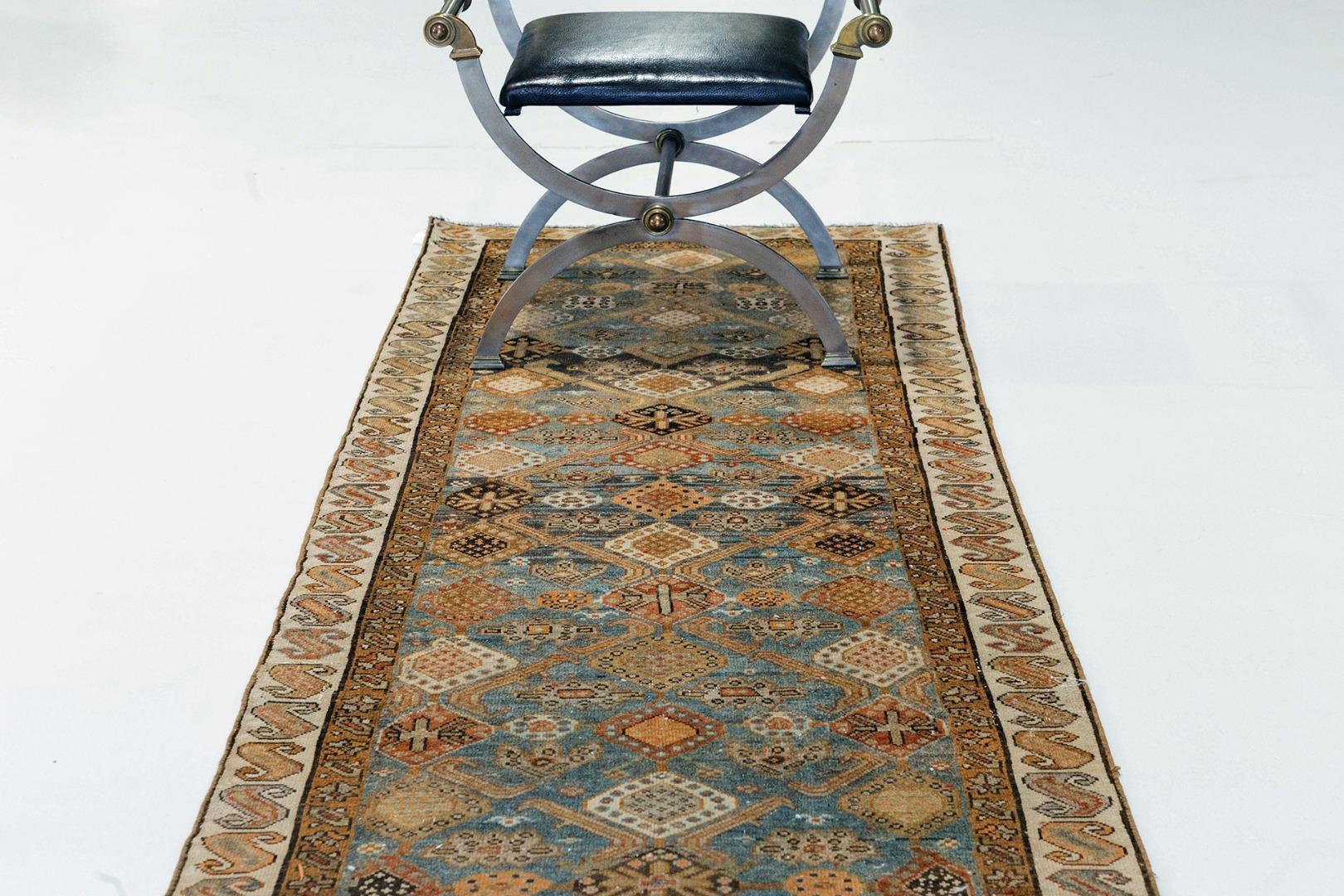A antique Persian Mahal runner with beautiful diamond shapes composing most of its field. Classic motifs in its surrounding borders add an elegant touch. This rugs ornate patterns and vibrant colors work together to bring a strong aesthetic appeal