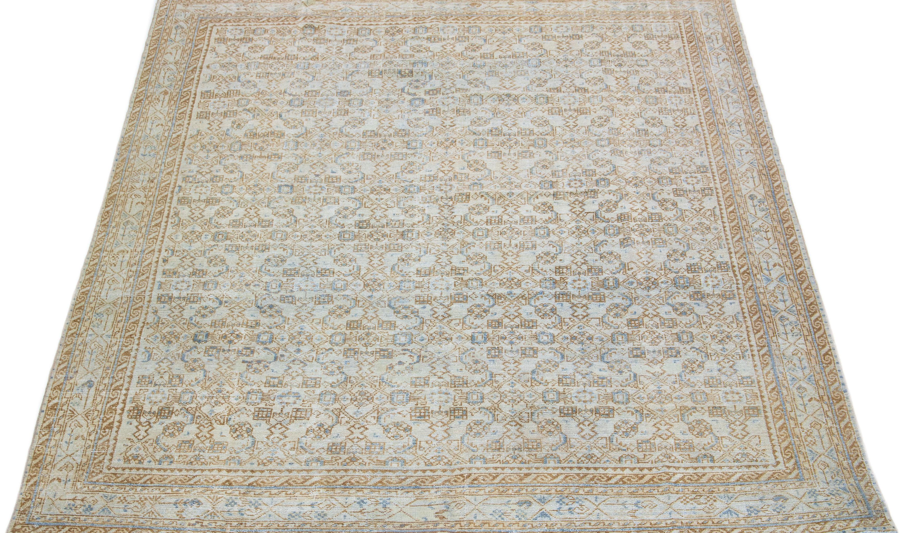 This hand-knotted Persian antique mahal wool rug features a beige field with exquisite blue accents cast across it in an all-over pattern.

This rug measures 8' x 9'9