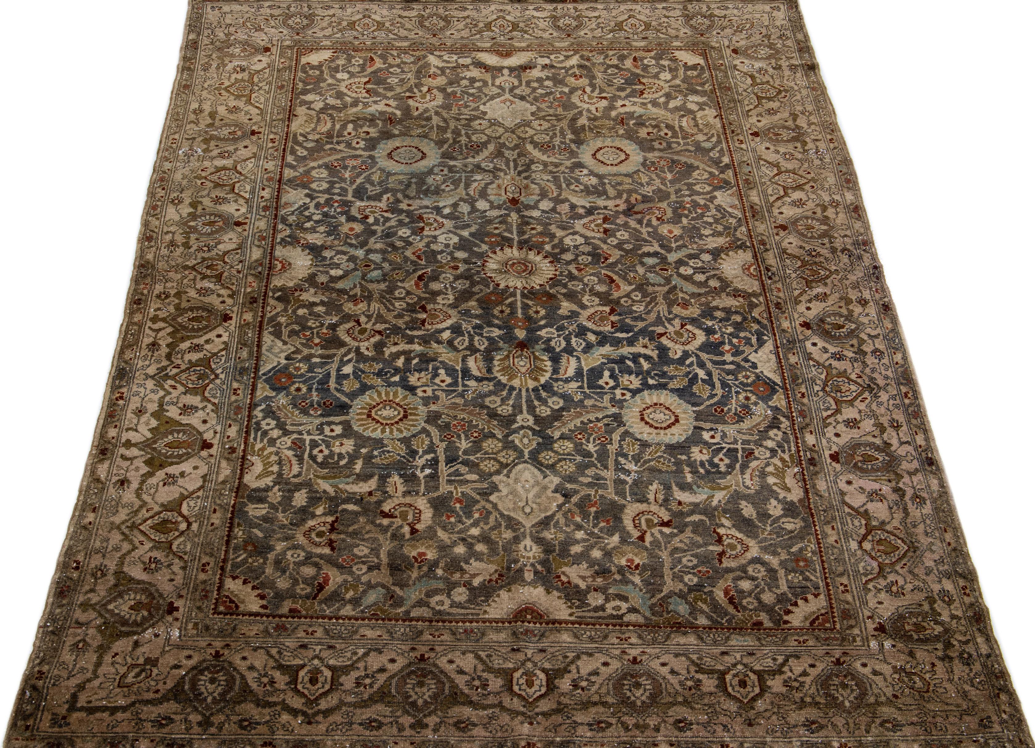 Beautiful Antique Malayer hand-knotted wool rug with a blue-gray color field. This Persian rug has a brown frame and multicolor accents in an all-over medallion floral design.

This rug measures 5'1