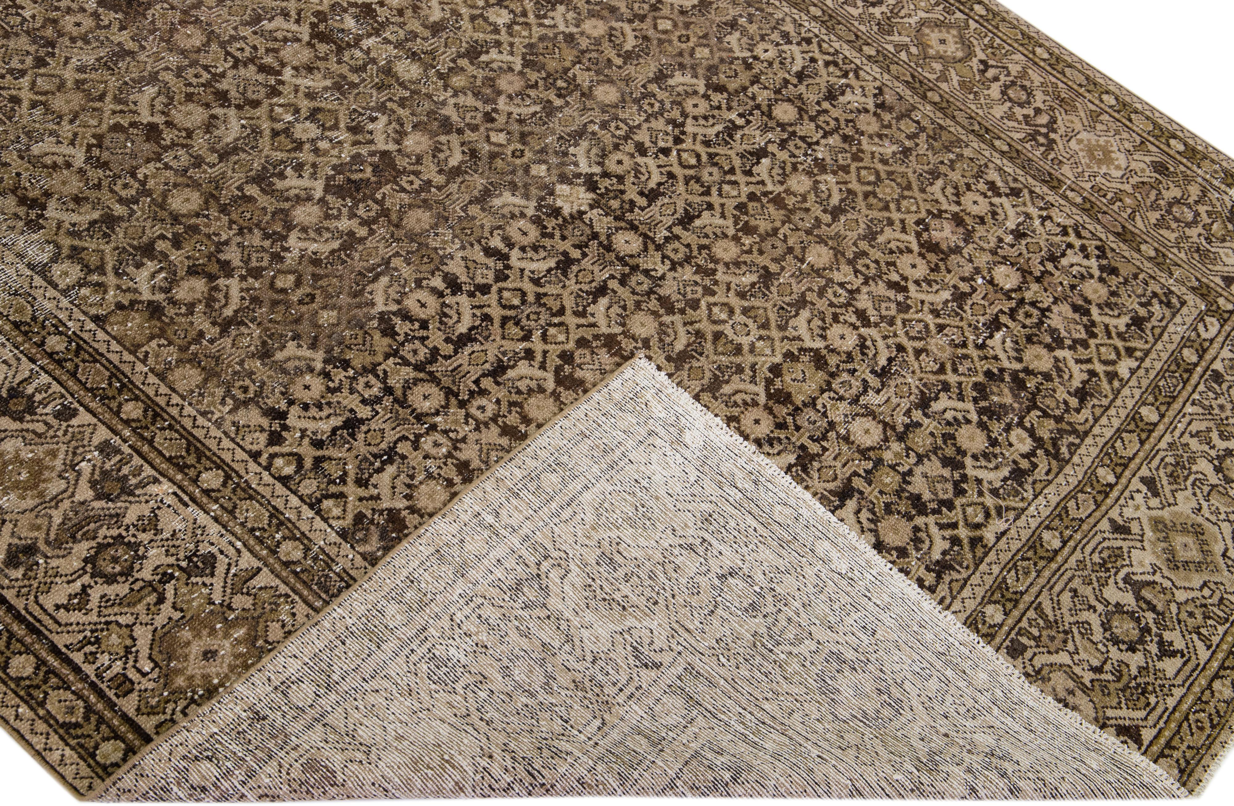 Beautiful antique Malayer hand-knotted wool rug with a brown color field. This Malayer piece has a designed frame with beige, red, and green accents in a gorgeous all-over geometric pattern design.

This rug measures: 6'3
