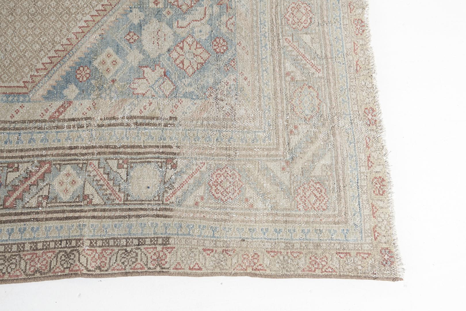 A magnificent Persian Malayer Runner that graces its dazzling design. Centrally focused in its intricate composition of lozenge medallions, this exhilirating rug features the muted tones of gold and cerulean blue. The attention to detail of this