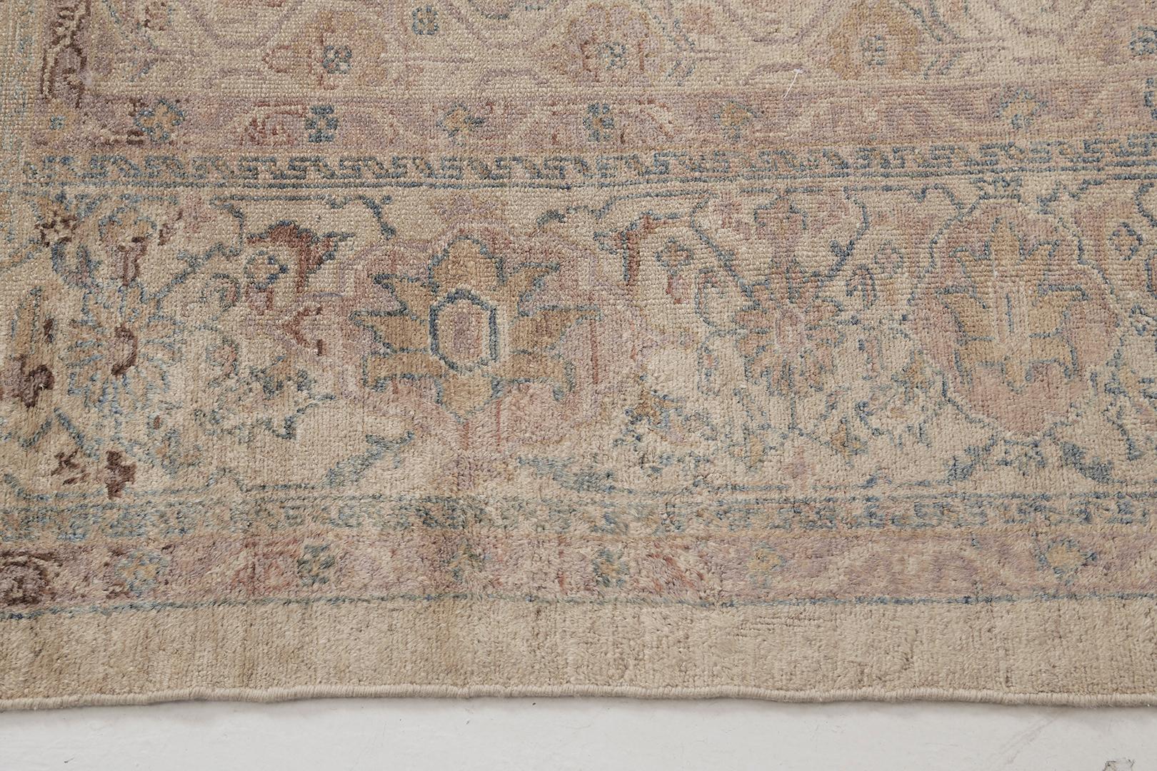 An enchanting antique Persian Malayer rug that features a sophisticated all over effect flourishing in the abrashed field in the most desirable earthy tones. Enclosed floral meander inner and outer guard band, this rug displays an elegant rapport to