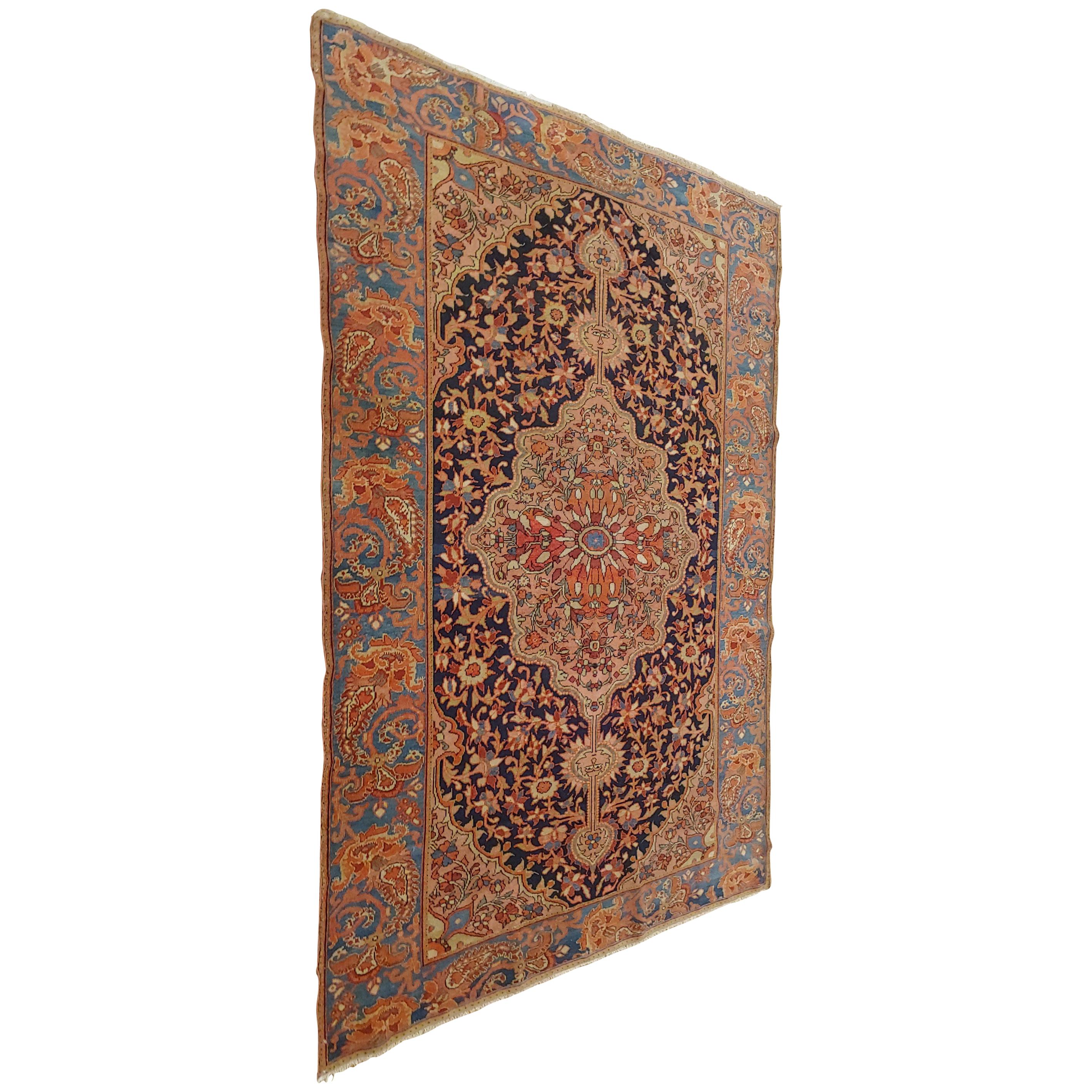 This antique Persian Malayer is from the Hamadan area. Malayer rugs are the finest rugs from the Hamadan region. This particular rug is very finely woven and is highly unusual because of the two smiley faces in the pattern of the rug. Also the
