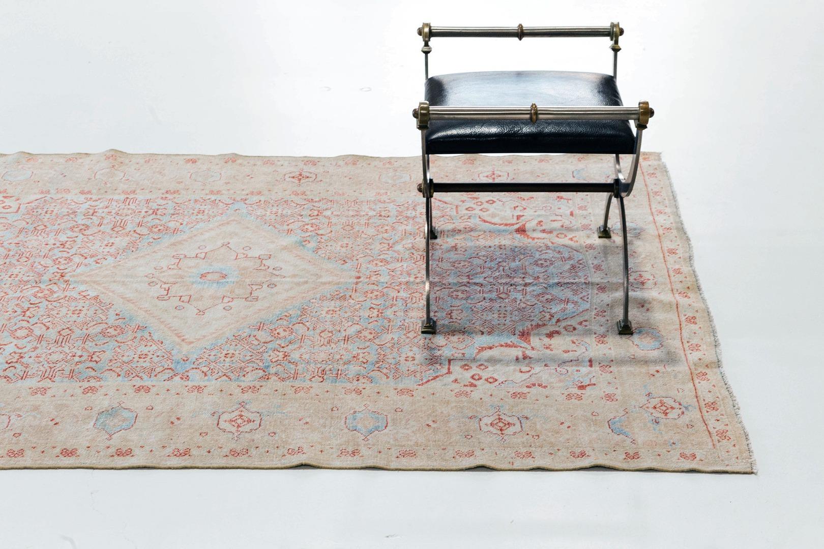 A beautiful and charming antique Persian Malayer from Iran. This piece consists of a central medallion and beautiful geometric motifs in the surrounding field. Soft pink, blues, and reds working together to create a luxurious and timely piece.
