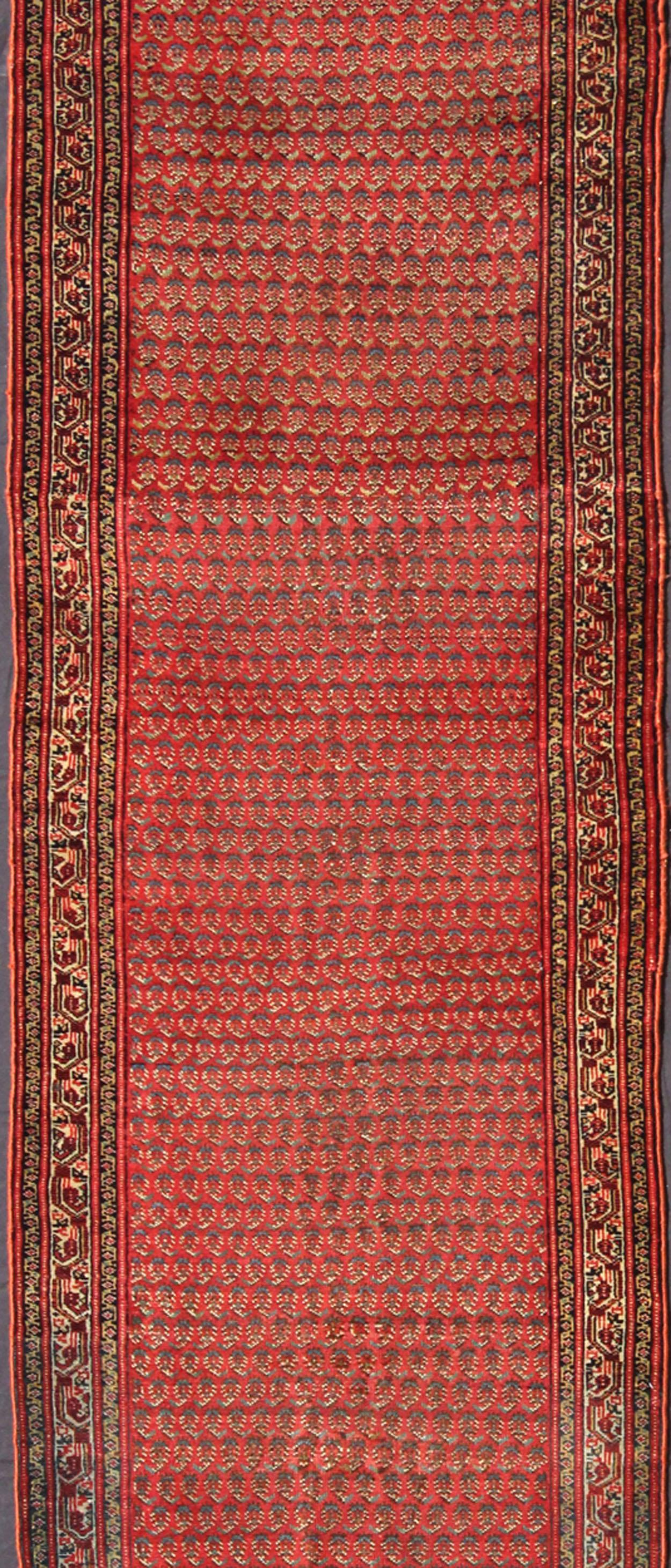 Measures: 3'1 x 21'3

This antique Persian Saraband gallery runner features an all-over paisley pattern set on a light red, rust red background and surrounded by multiple  borders with hints of green and ivory.

Country of Origin: Iran; Type: