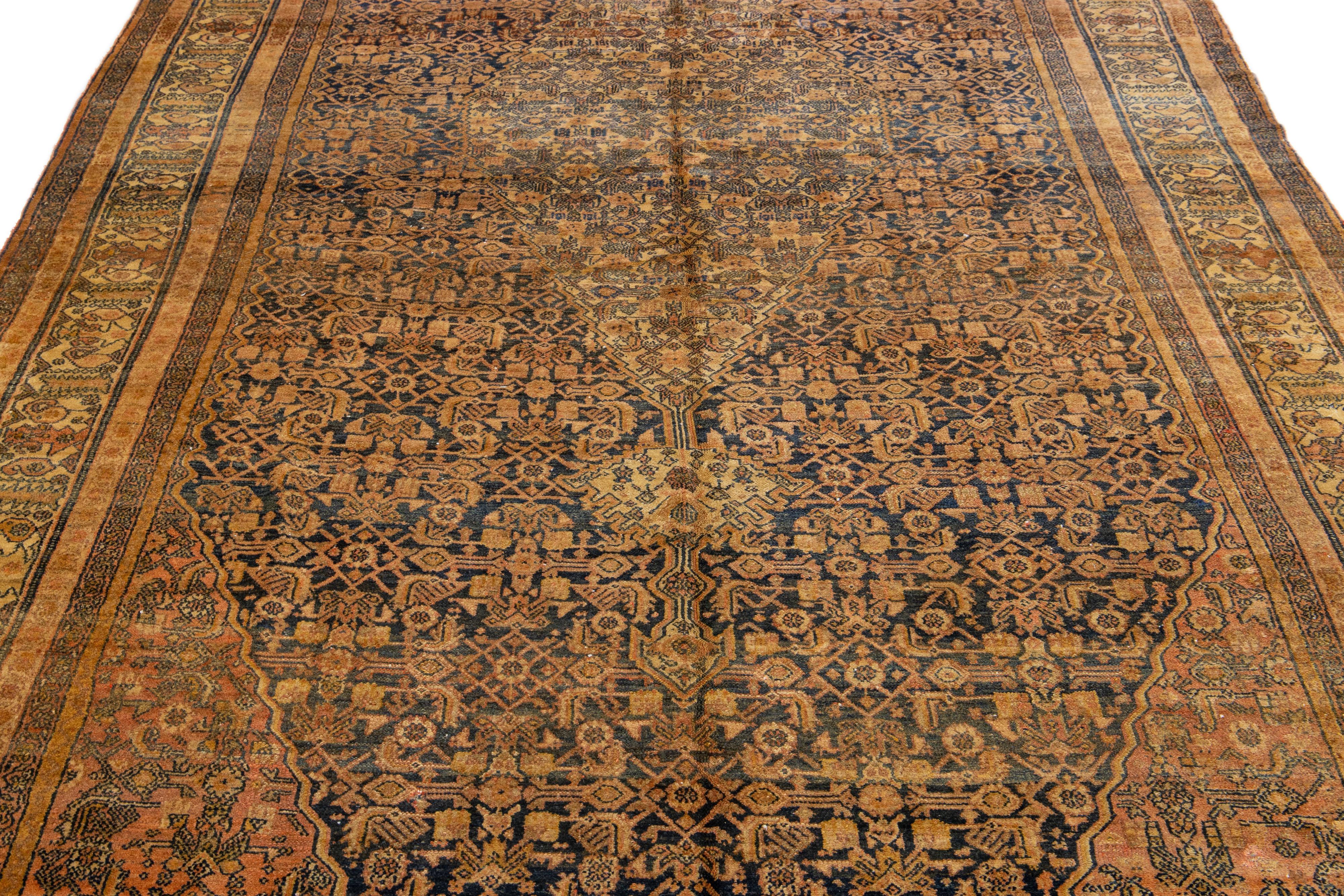 This stunning antique Persian Malayer rug is fashioned from meticulously hand-knotted wool, featuring a serene gray field adorned with tan accents in an exquisite all-over classic design.

This rug measures 7'2