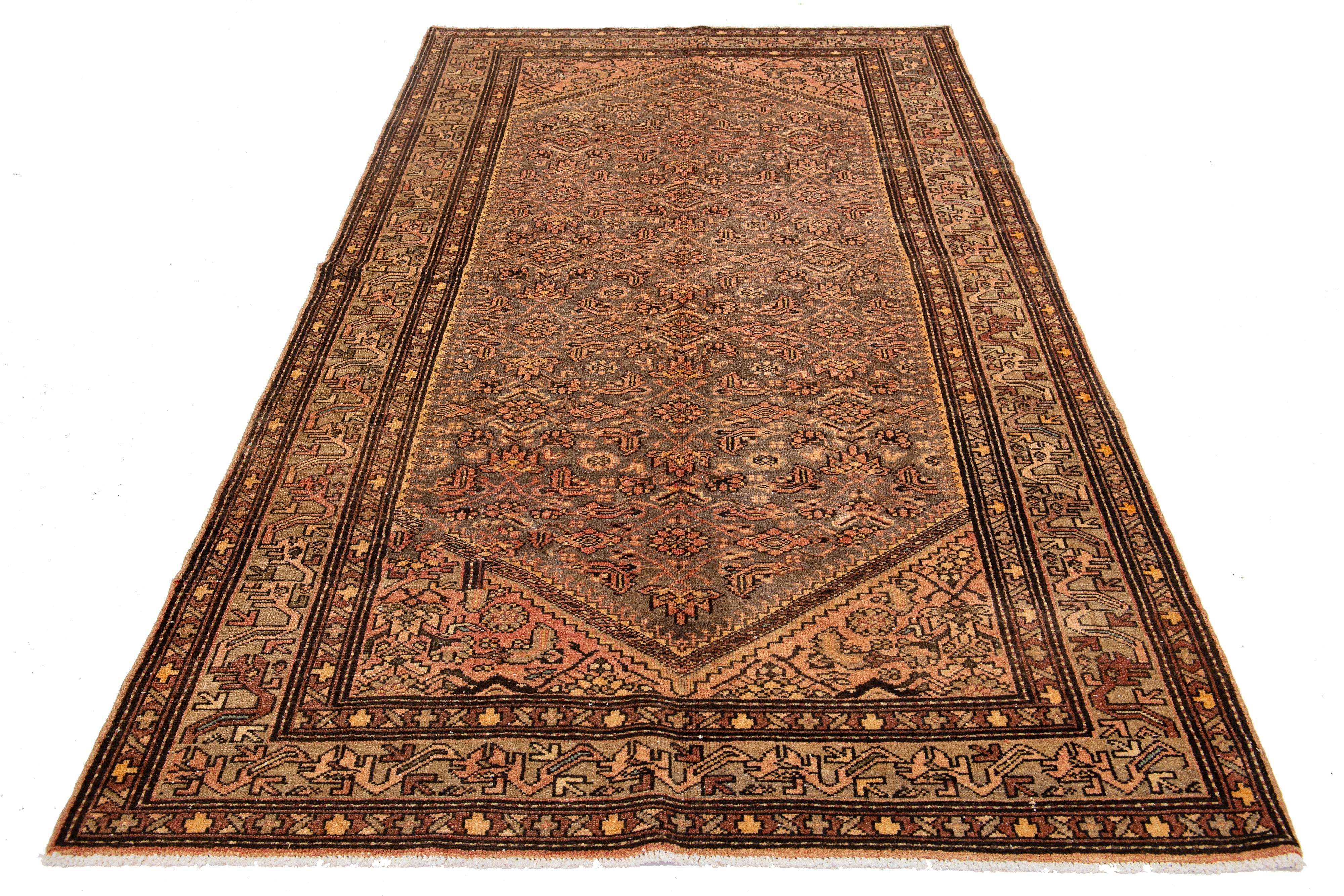 This exceptional antique Persian Malayer rug is crafted from hand-knotted wool. The design features a beautiful combination of gray and rust as the base, enhanced with blue, orange, and brown highlights in a stunning and intricately detailed