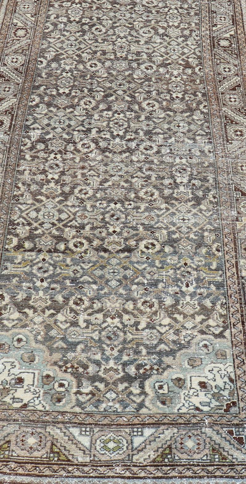 This antique Persian  Malayer runner is rendered in shades of brown, blue, cream and gray. The field and the border both hold an all-over design. 
Measures; 3'6 x 13'5
Country of Origin: Iran Type: Malayer  Design: Herati, All-Over, 