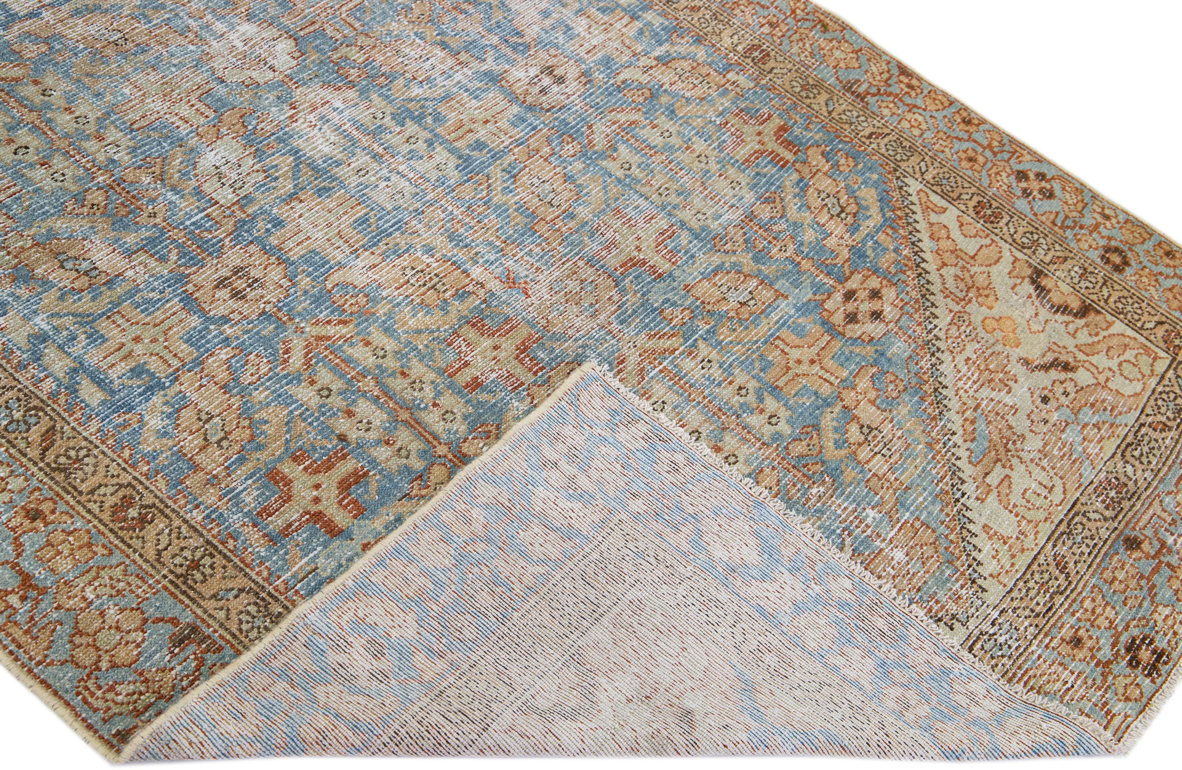 Beautiful antique Malayer hand-knotted wool rug with a blue field. This Persian piece has tan and brown accents in a gorgeous all-over floral design.

This rug measures: 4'8