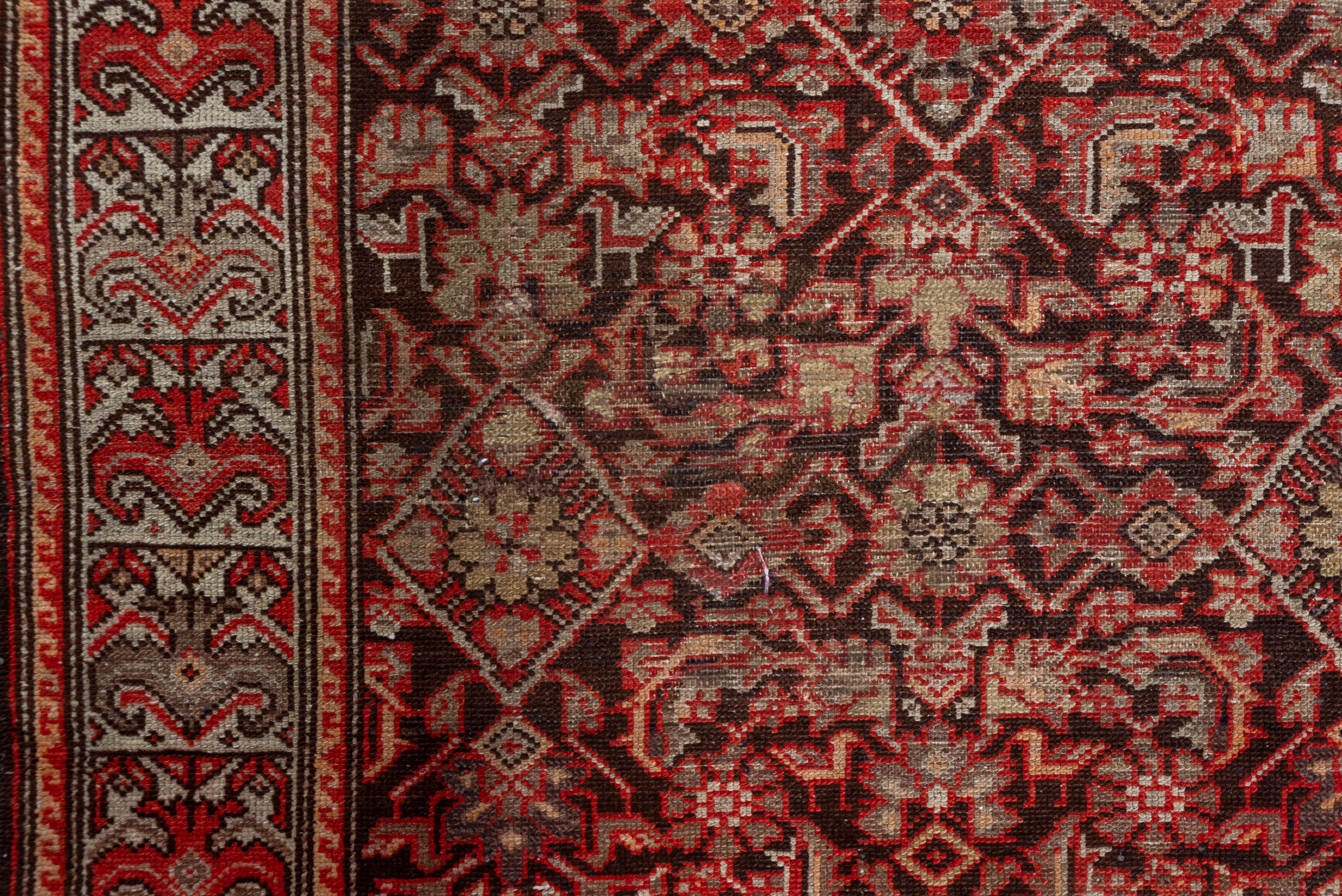 The abrashed sienna field shows a three column Herati allover Herati design with 