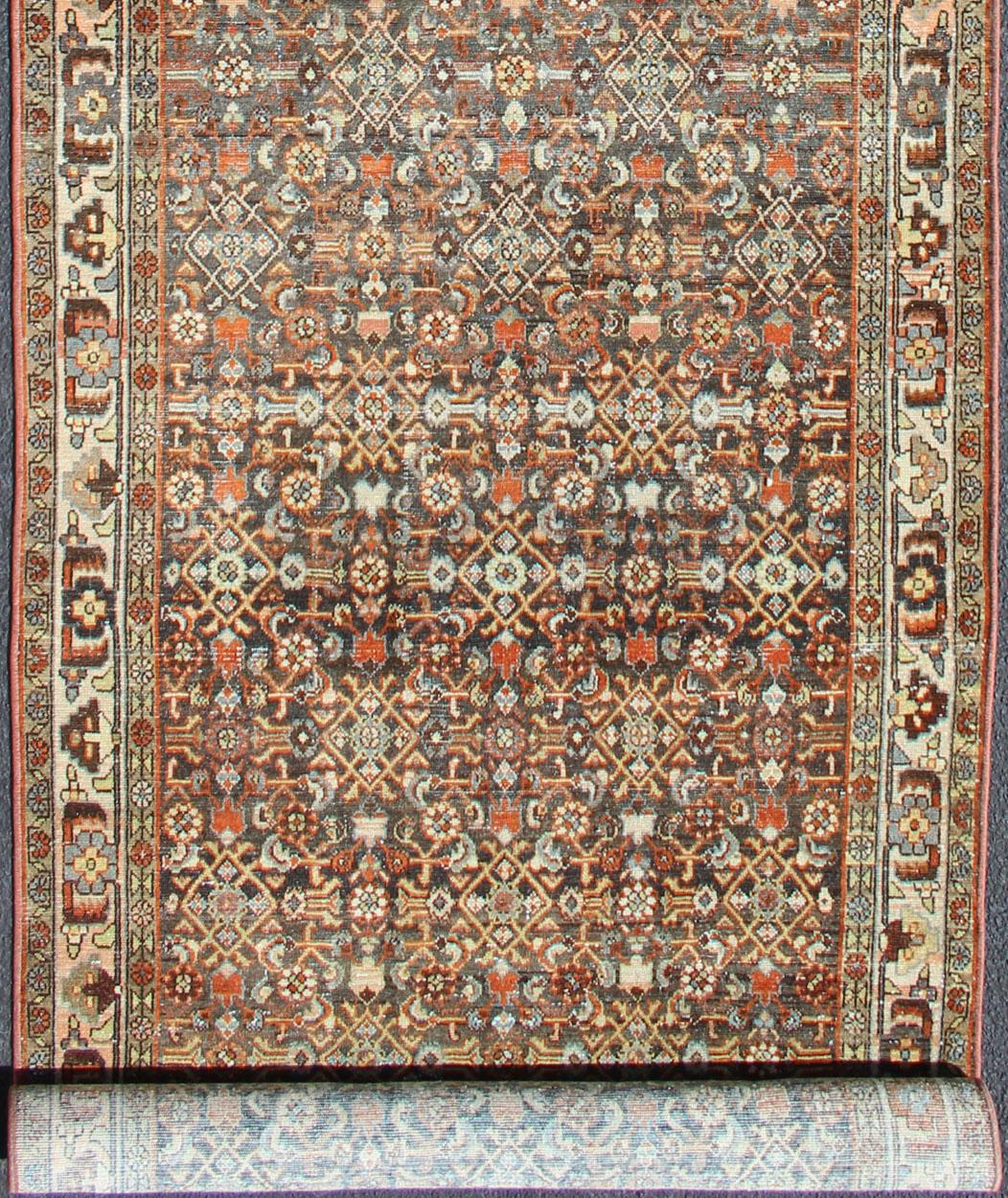 Long Persian Malayer runner with geometric motifs, rug SUS-1908-212, country of origin / type: Iran / Malayer, circa 1920

This long antique Persian Malayer runner, circa 1920s, is an intricate and unique piece. The central field plays host to an