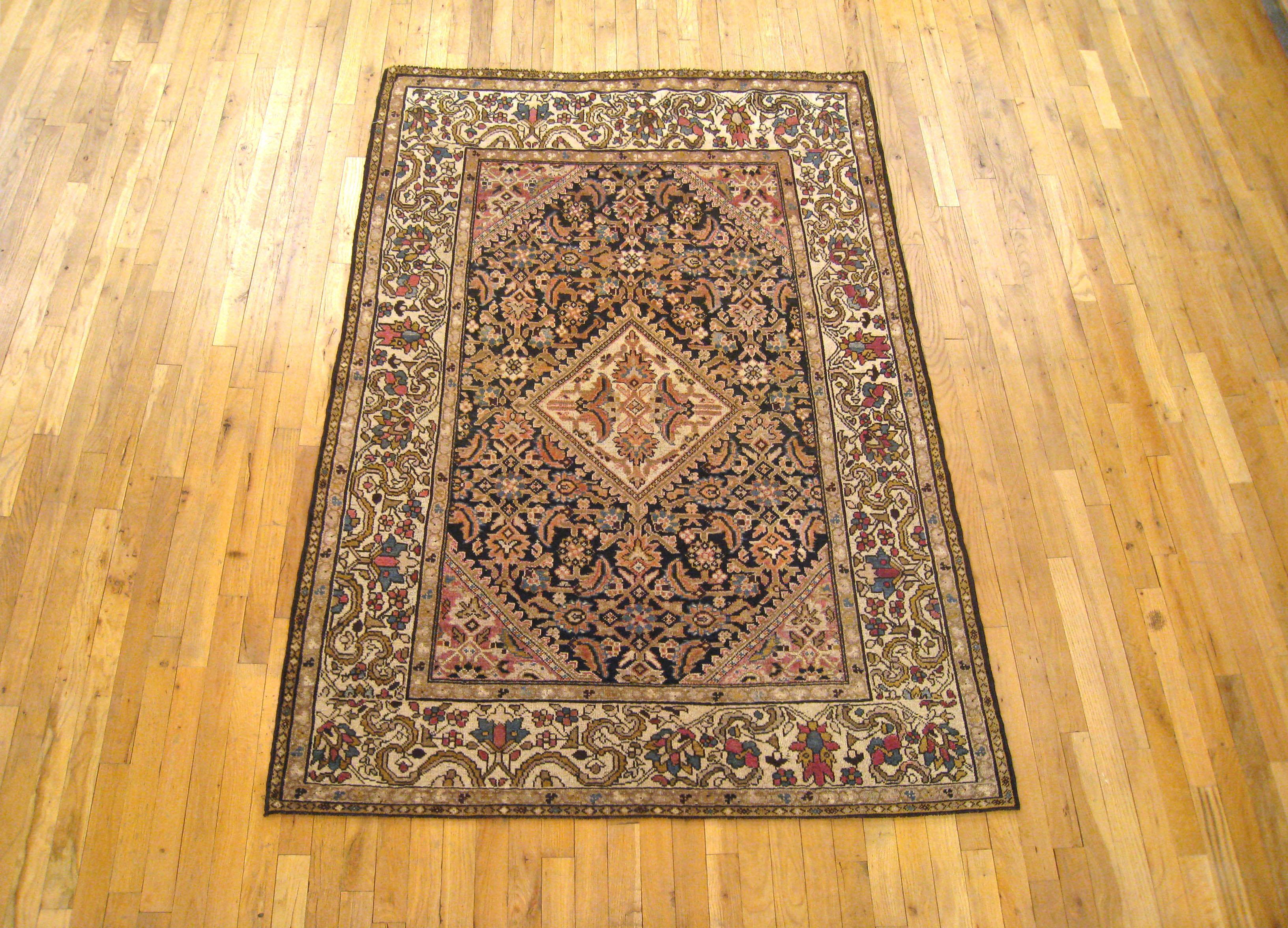 Antique Persian Malayer Oriental rug in Small Size with Ivory Medallion & Border

An antique Persian Malayer oriental rug, circa 1920. Size 6'6