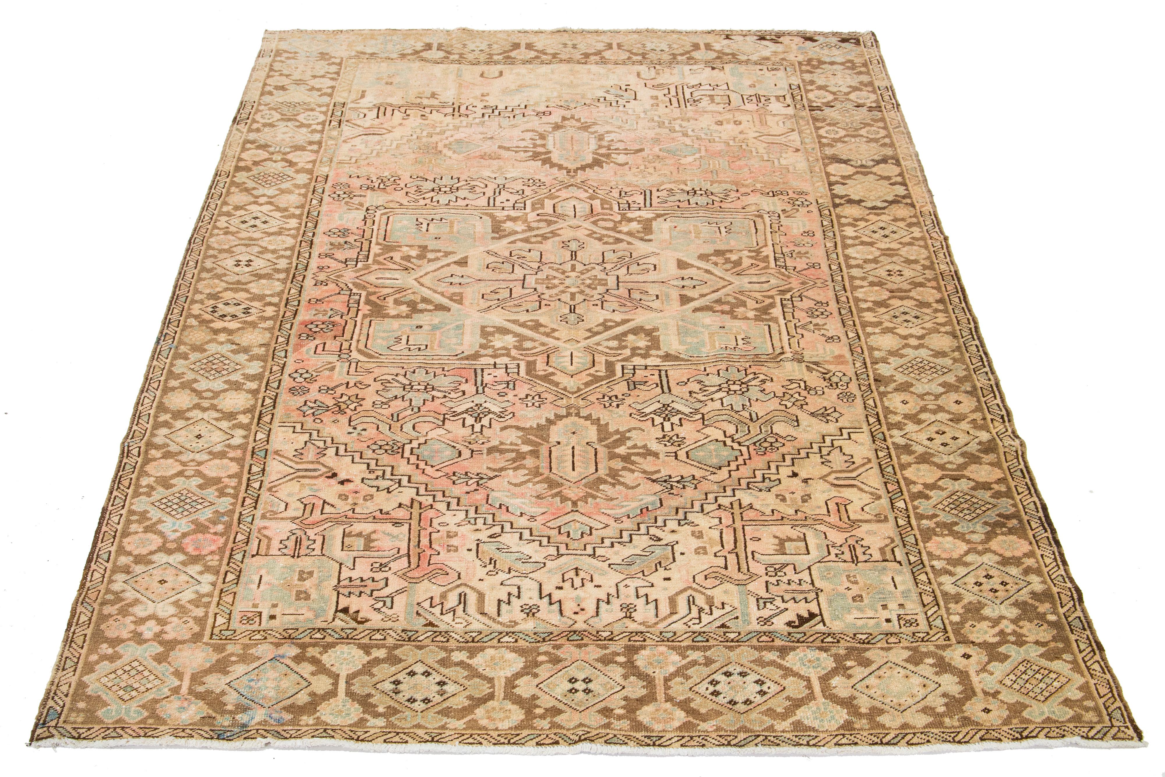 Beautiful room-size antique Malayer hand-knotted wool rug with a peach color field. This Persian rug has a gorgeous medallion design with blue and brown accents.

This rug measures 8'1