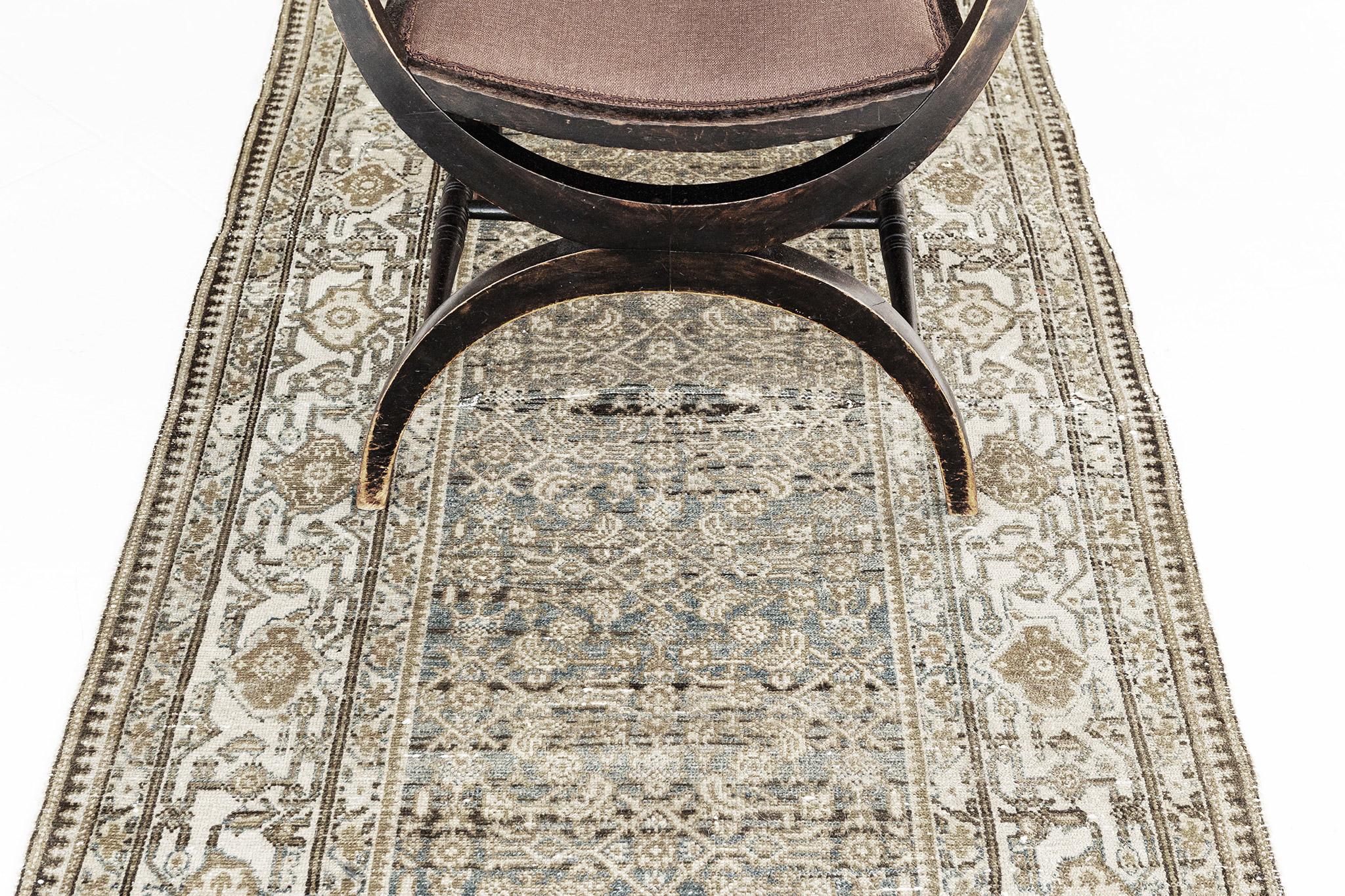 A majestic masterpiece from the Persian Malayer rug features a captivating design. The astonishing traditional pattern is framed by a bronze, blue, and gold design. A lustrous centerpiece that will bring elegance to every style you could ever dream