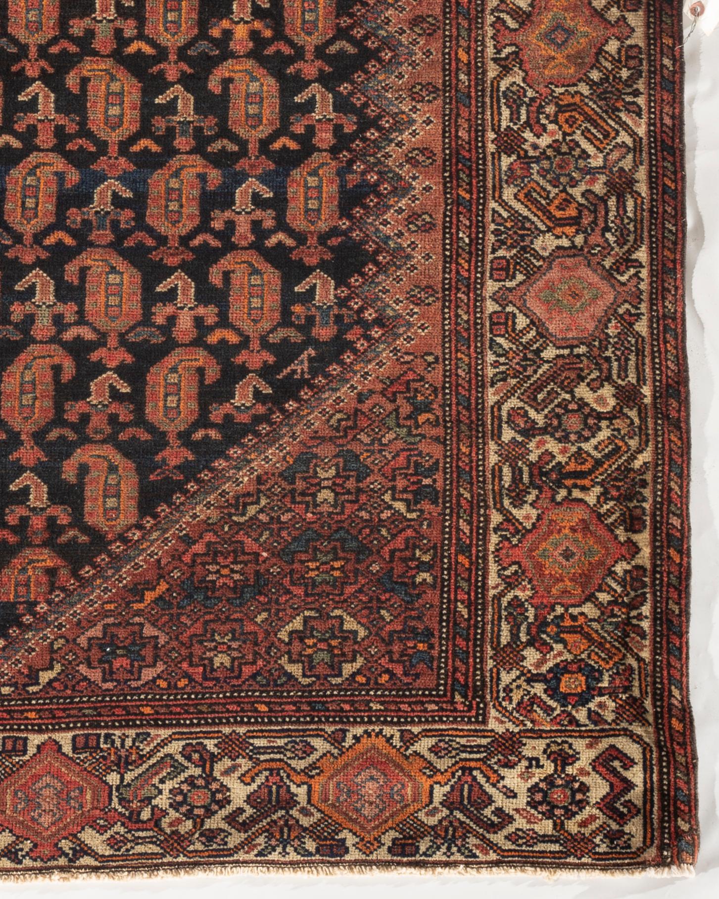 Antique Persian Malayer rug, circa 1900. The central deep navy field filled with boteh’s and surrounded by an ivory border with floral designs to create this charming looking and harmonious rug. Antique rugs from Malayer, east of Hamadan, could be