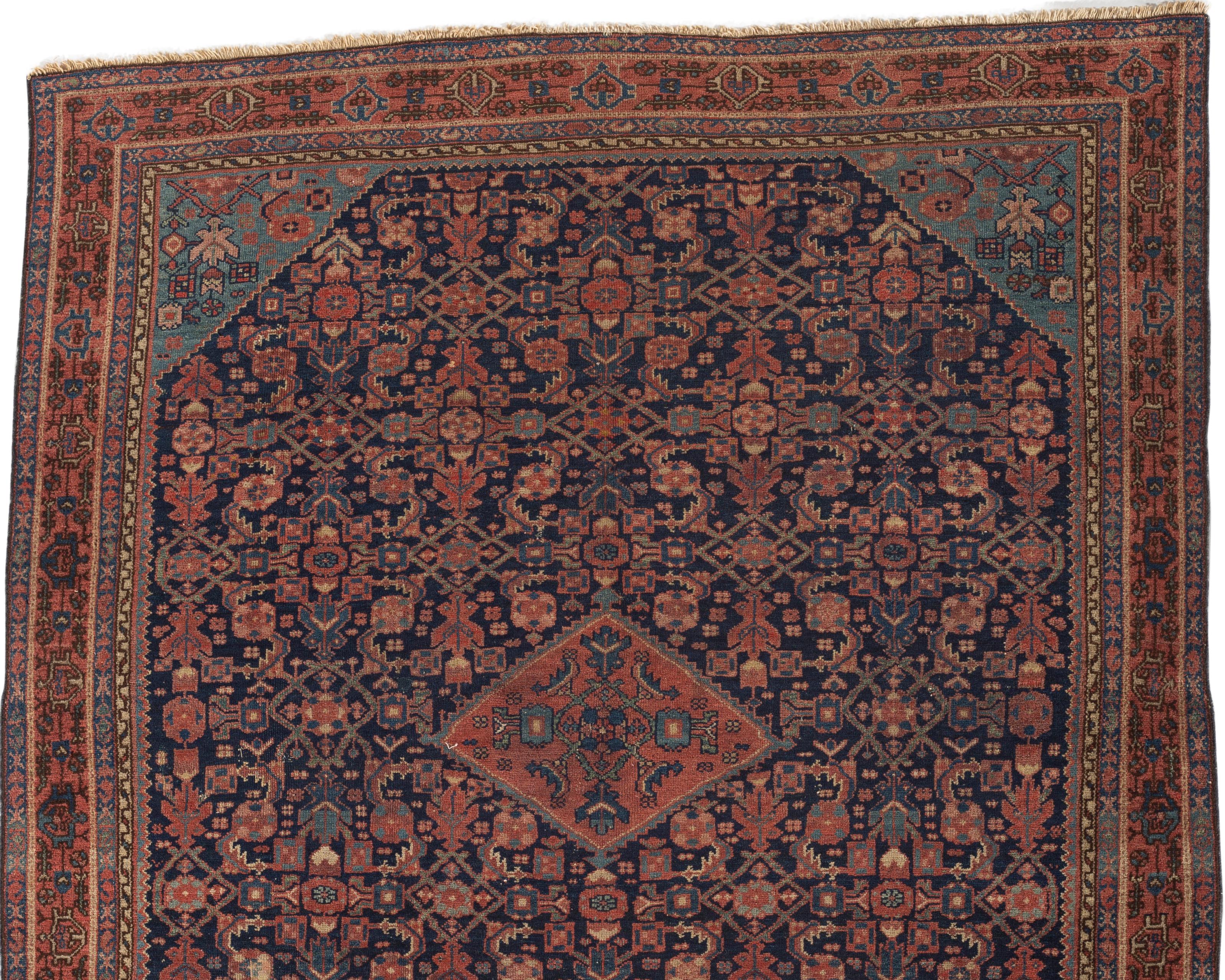 Antique Persian Malayer rug, circa 1900. Antique rugs from Malayer, east of Hamadan, could be considered top quality Hamadan’s and they share similar structural aspects. This lovely small scatter rug has a deep navy field filled with an array of