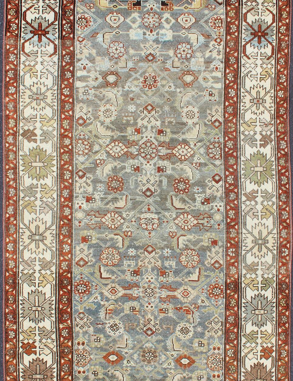 Light gray background and terracotta red guard border, with all-over tribal design, Persian antique Malayer rug, rug SUS-2007-226, country of origin / type: Iran / Malayer, circa 1920.

This beautiful antique early 20th century Persian Malayer