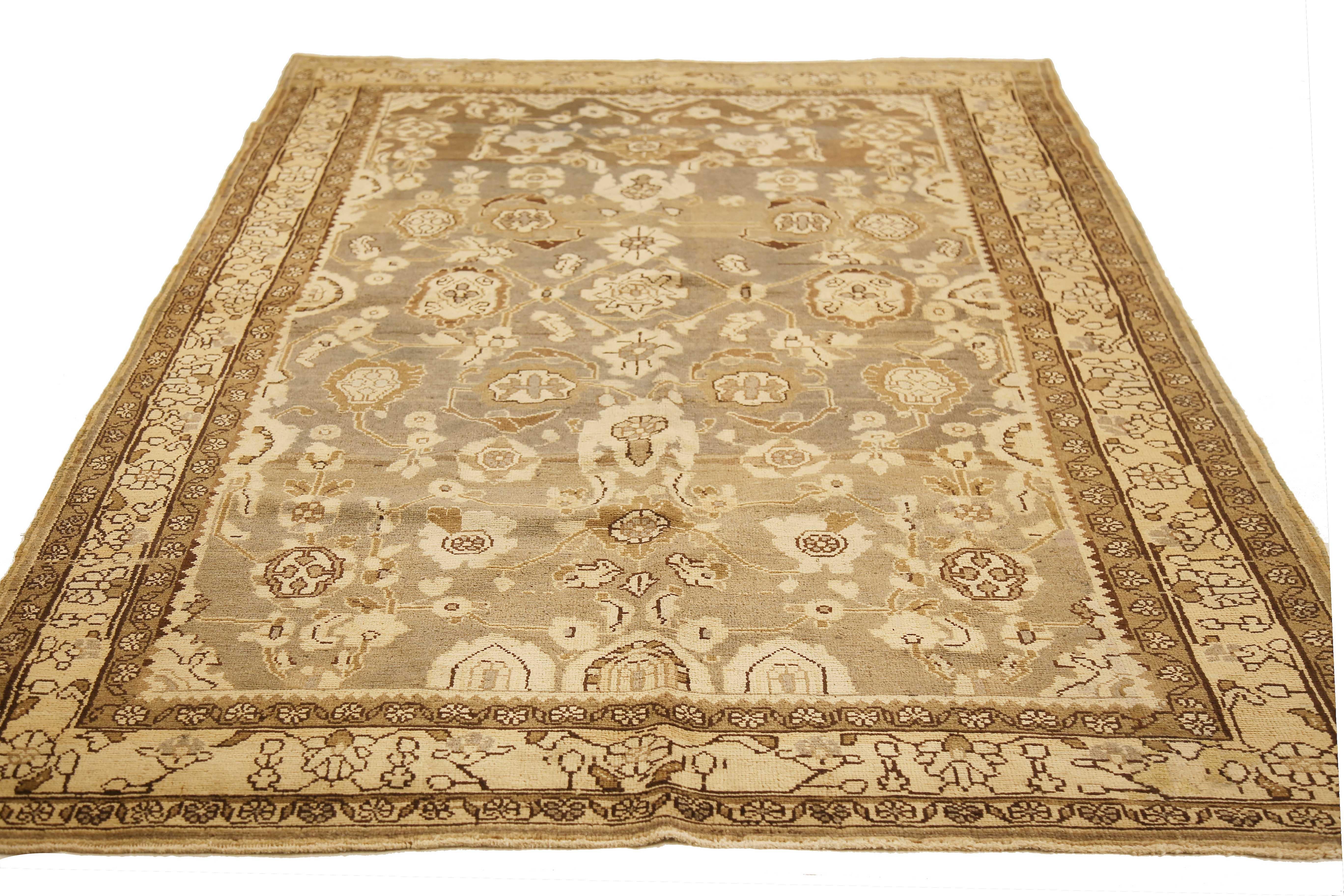 Antique Persian rug handwoven from the finest sheep’s wool and colored with all-natural vegetable dyes that are safe for humans and pets. It’s a traditional Malayer design featuring beige and brown botanical details on the ivory and gray field. It’s