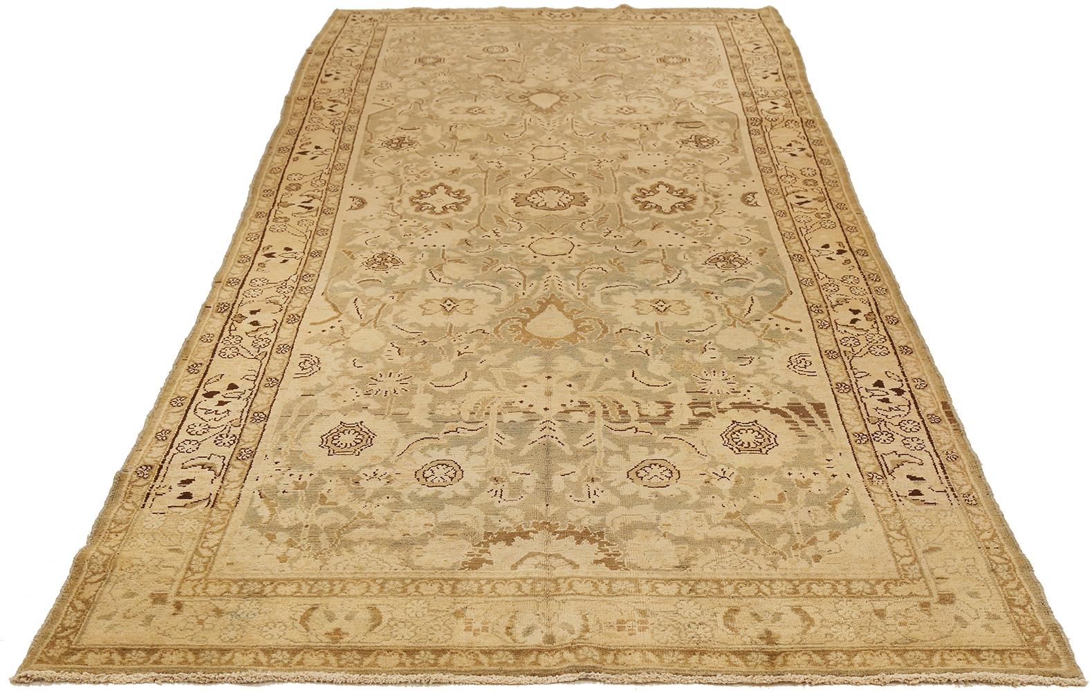Antique Persian rug handwoven from the finest sheep’s wool and colored with all-natural vegetable dyes that are safe for humans and pets. It’s a traditional Malayer design featuring beige and brown floral details over an ivory field. It’s a lovely