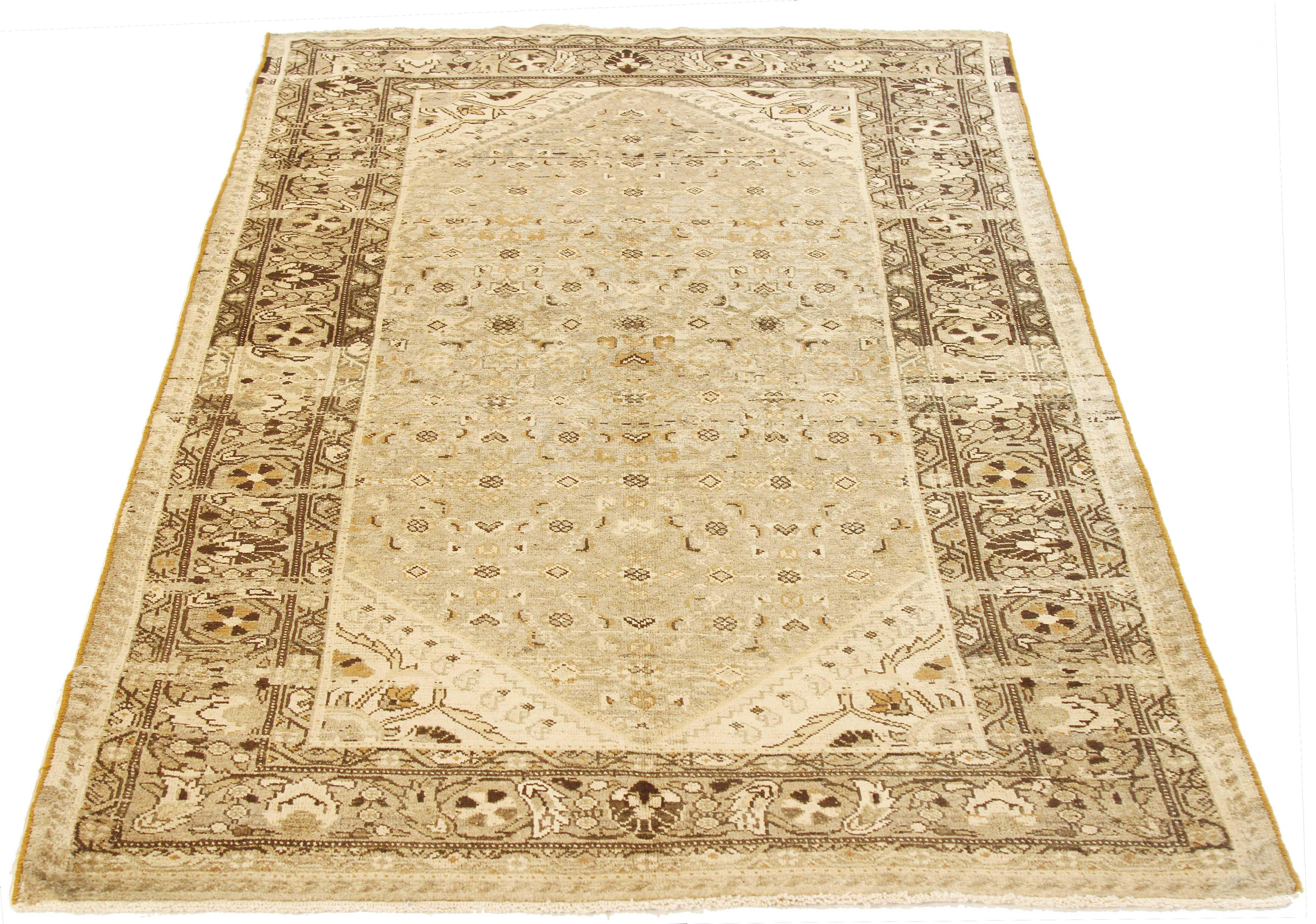 Antique Persian rug handwoven from the finest sheep’s wool and colored with all-natural vegetable dyes that are safe for humans and pets. It’s a traditional Malayer design featuring beige and brown floral details on an ivory field. It’s a lovely