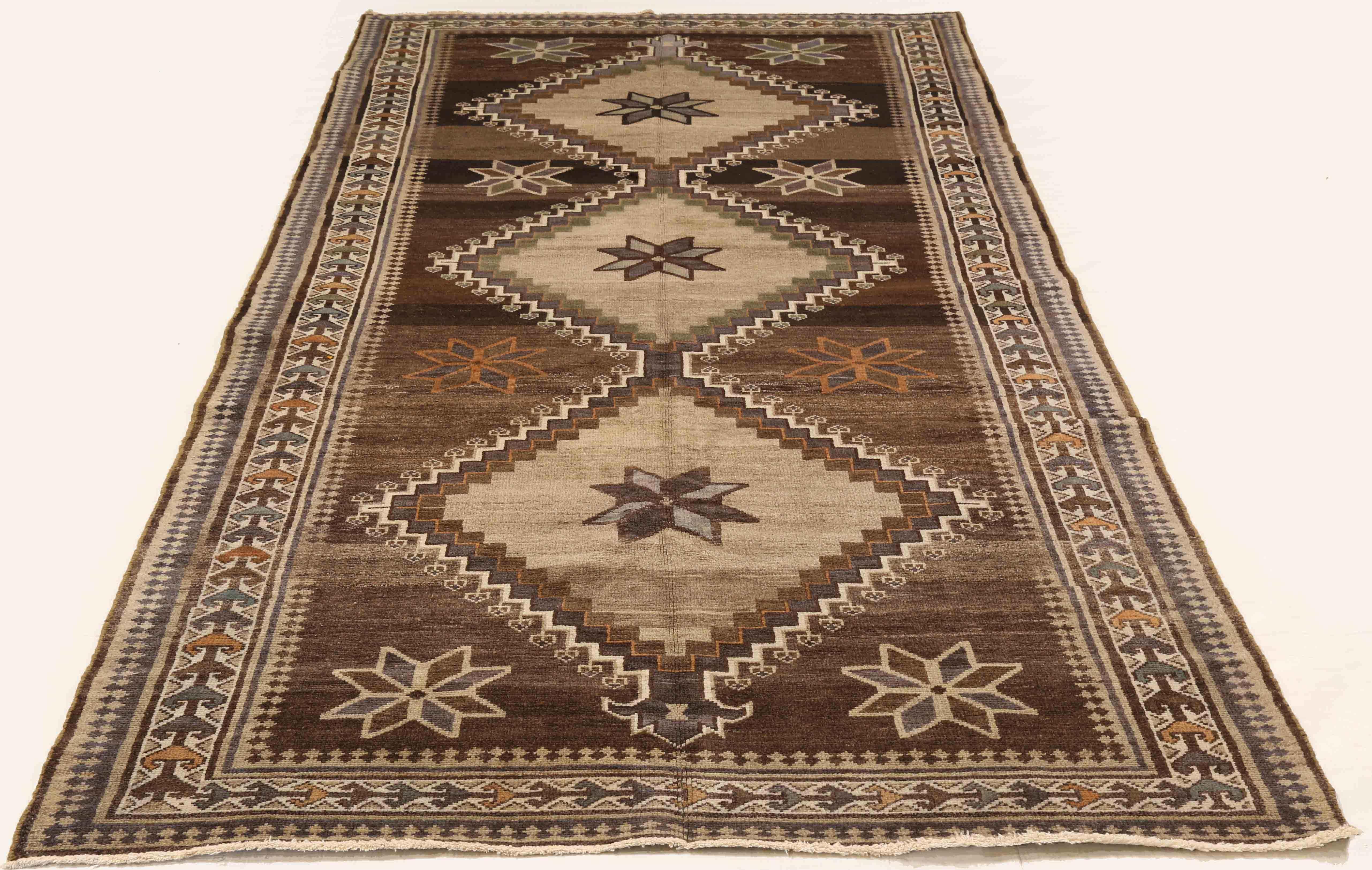 Antique Persian rug handwoven from the finest sheep’s wool. It’s colored with all-natural vegetable dyes that are safe for humans and pets. It’s a traditional Malayer design featuring brown and beige floral details over an ivory field. It’s a lovely