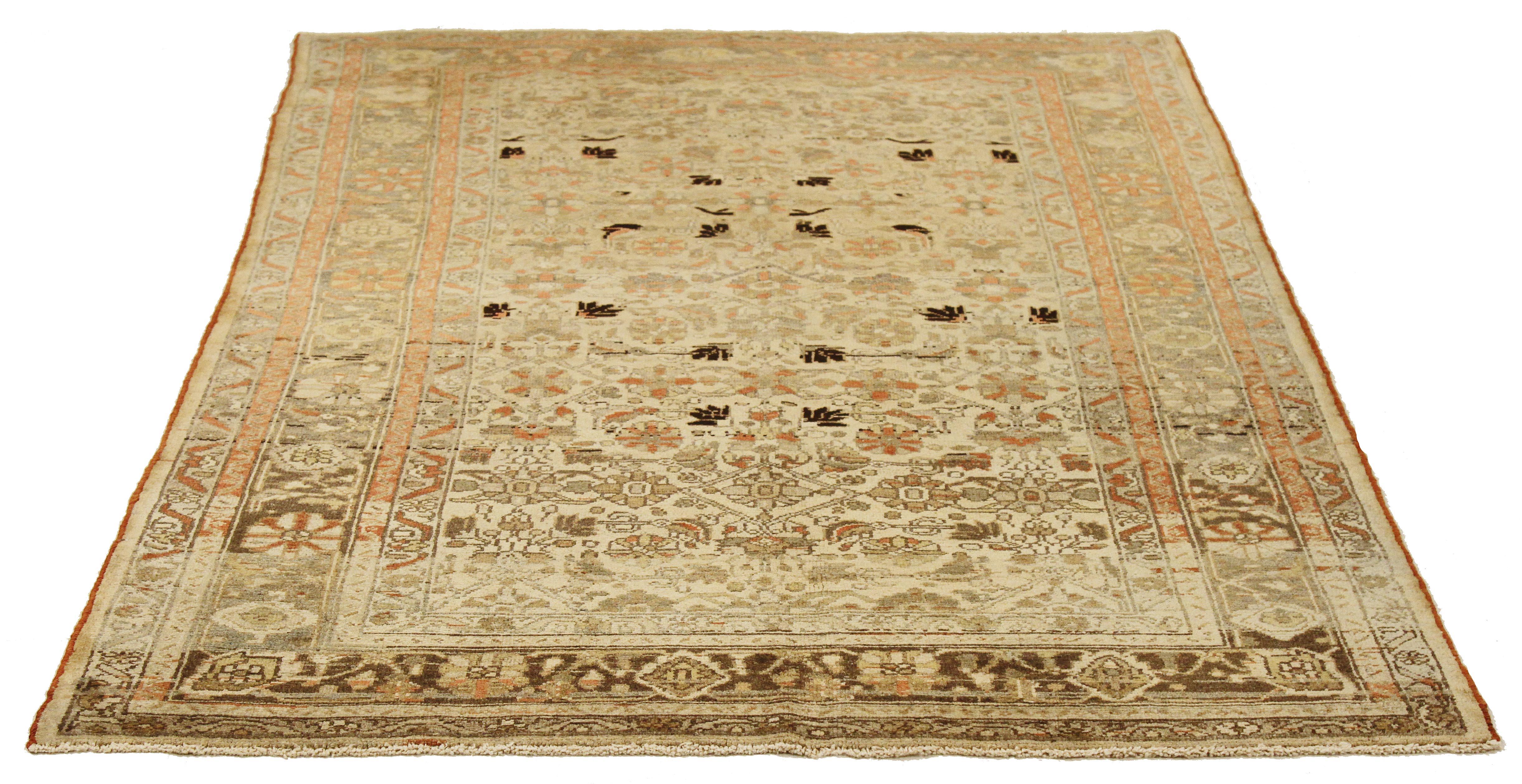 Antique Persian rug handwoven from the finest sheep’s wool and colored with all-natural vegetable dyes that are safe for humans and pets. It’s a traditional Malayer design featuring black and green flower head details all-over the ivory and gray
