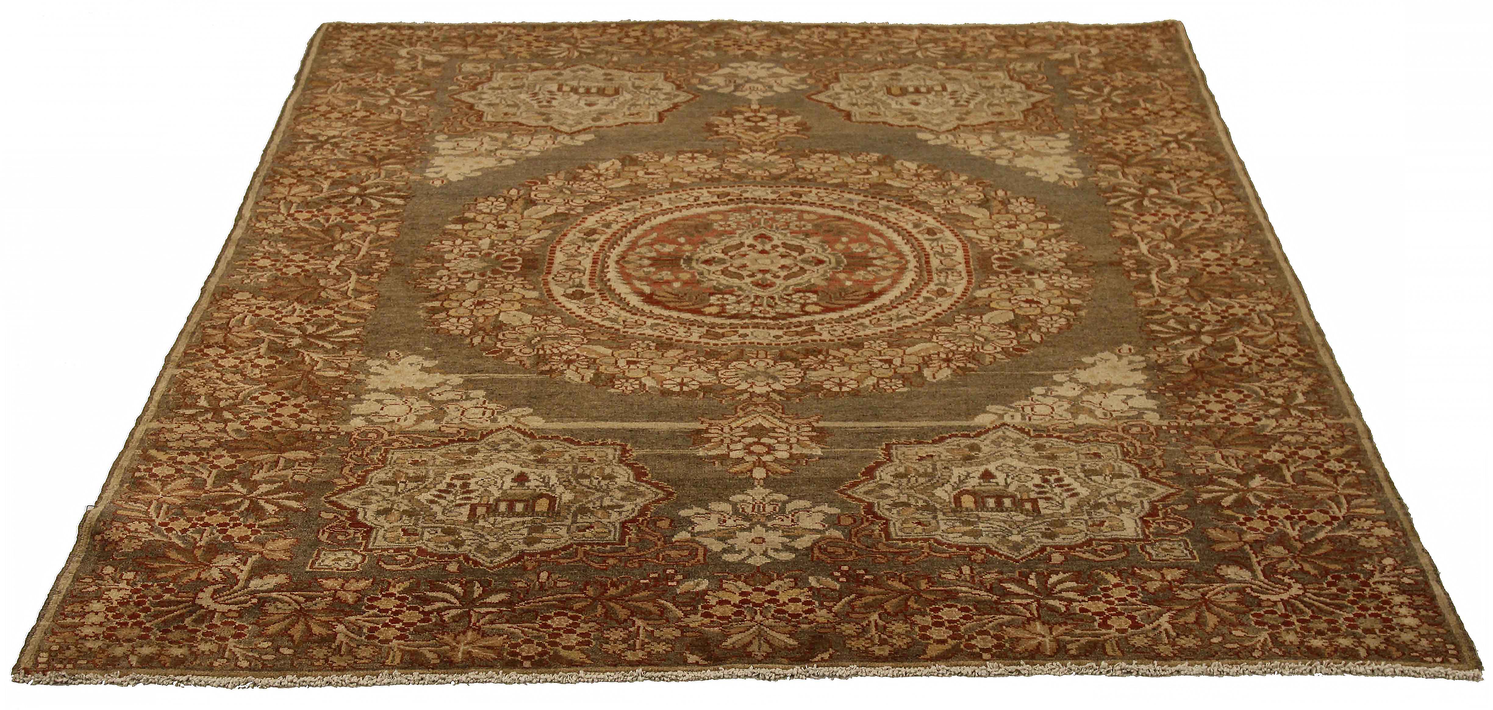 Antique Persian rug handwoven from the finest sheep’s wool. It’s colored with all-natural vegetable dyes that are safe for humans and pets. It’s a traditional Malayer design featuring brown and beige floral details over an ivory field. It’s a lovely