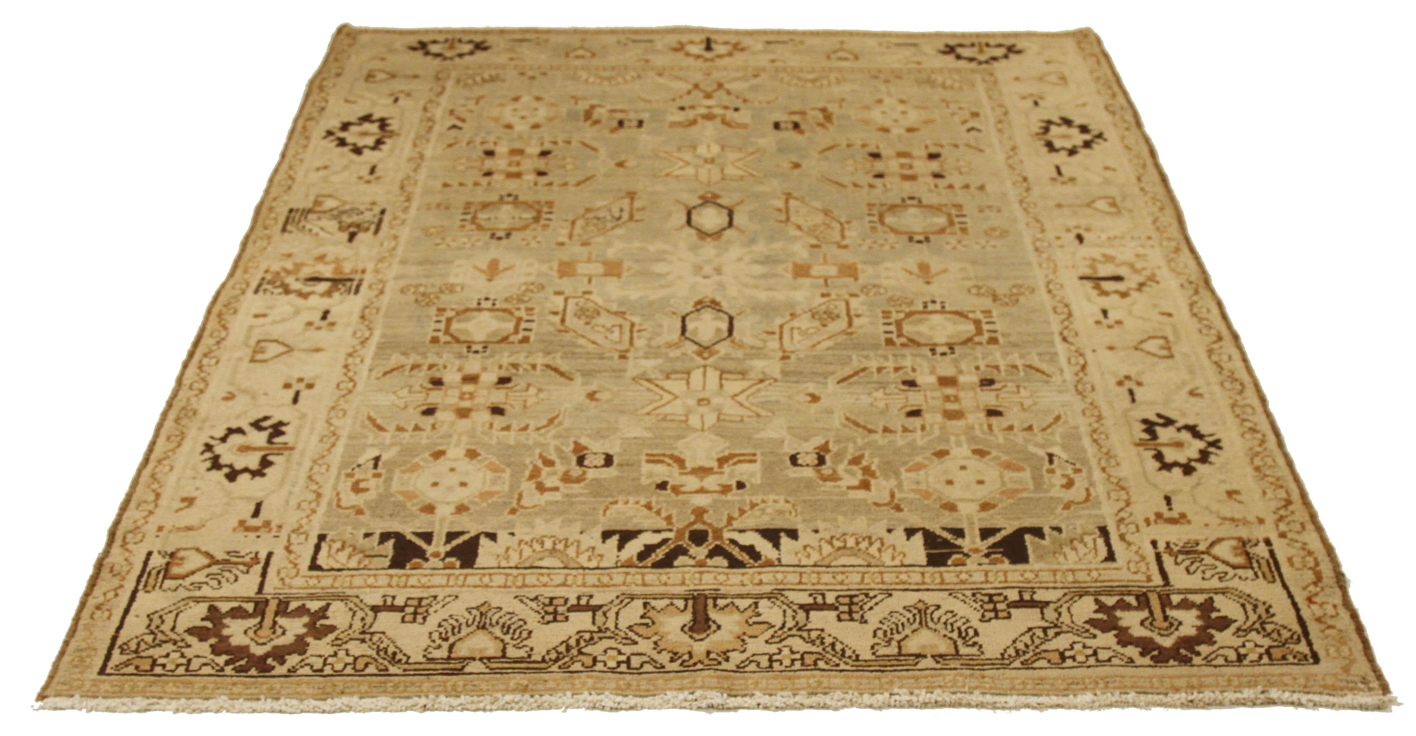 Antique Persian rug handwoven from the finest sheep’s wool and colored with all-natural vegetable dyes that are safe for humans and pets. It’s a traditional Malayer design featuring brown tribal details on an ivory field. It’s a lovely piece to