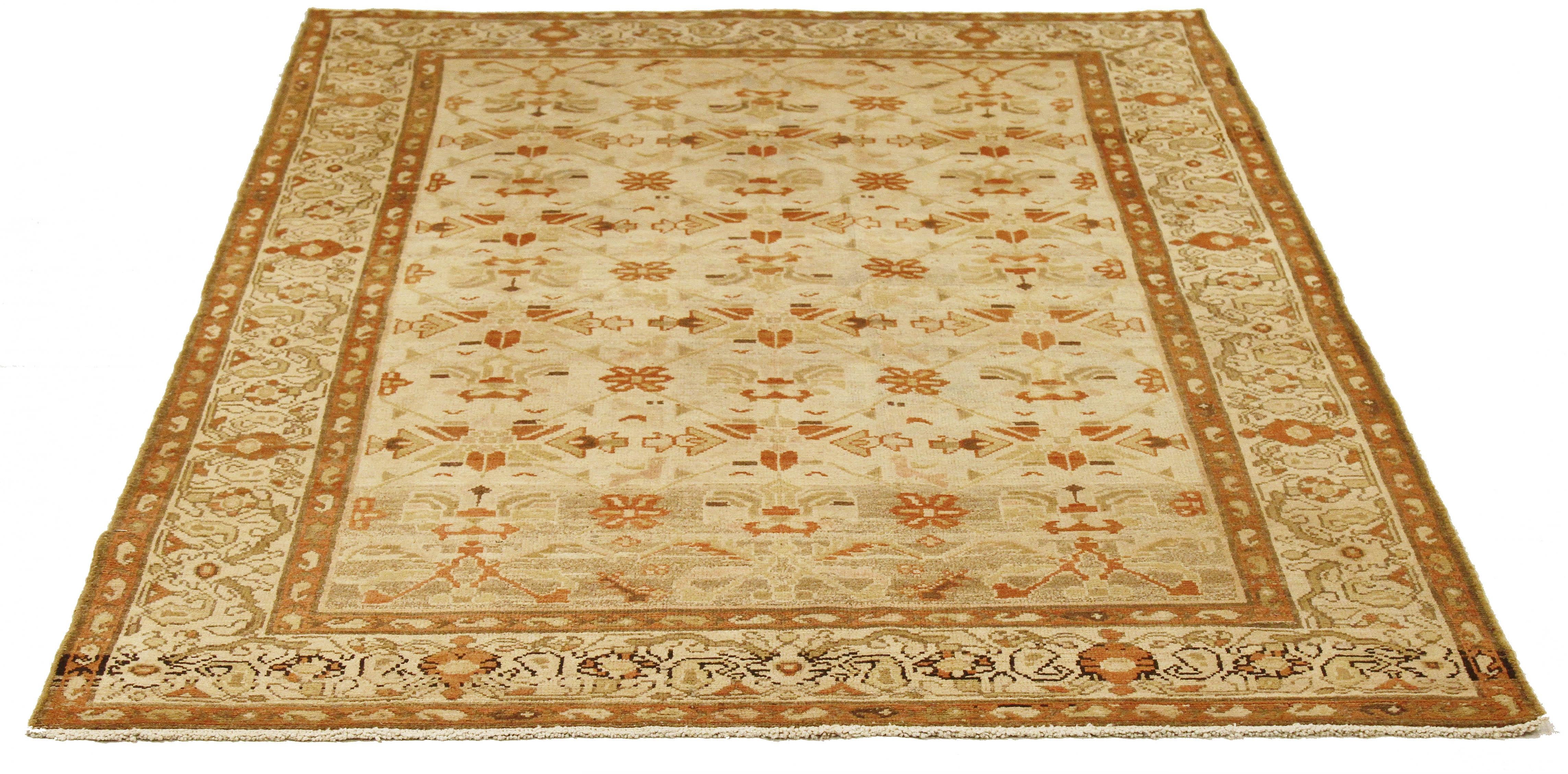 Antique Persian rug handwoven from the finest sheep’s wool and colored with all-natural vegetable dyes that are safe for humans and pets. It’s a traditional Malayer design featuring brown and beige tribal details on an ivory field. It’s a lovely