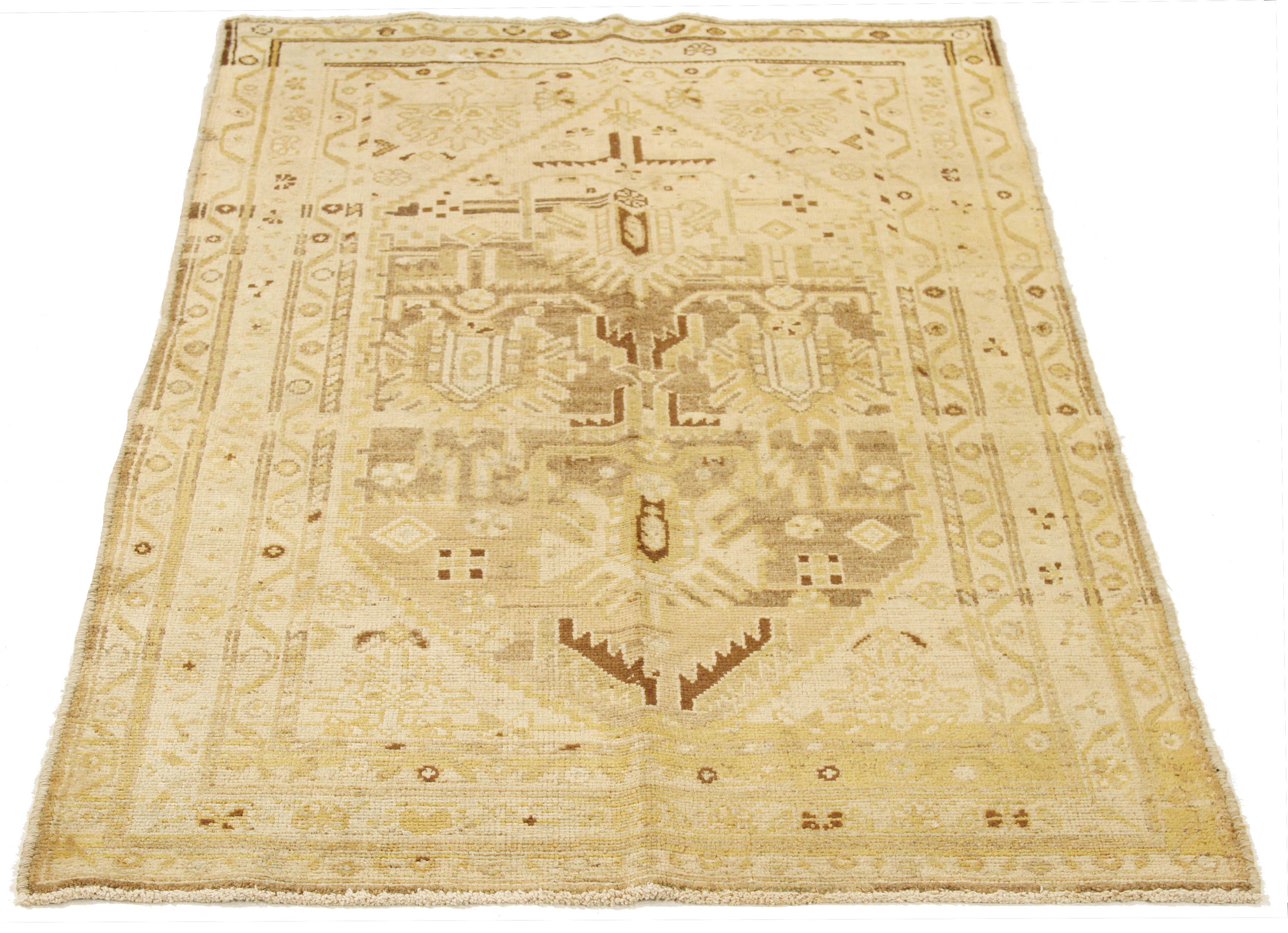 Antique Persian rug handwoven from the finest sheep’s wool and colored with all-natural vegetable dyes that are safe for humans and pets. It’s a traditional Malayer design featuring brown and beige tribal details over an ivory field. It’s a lovely