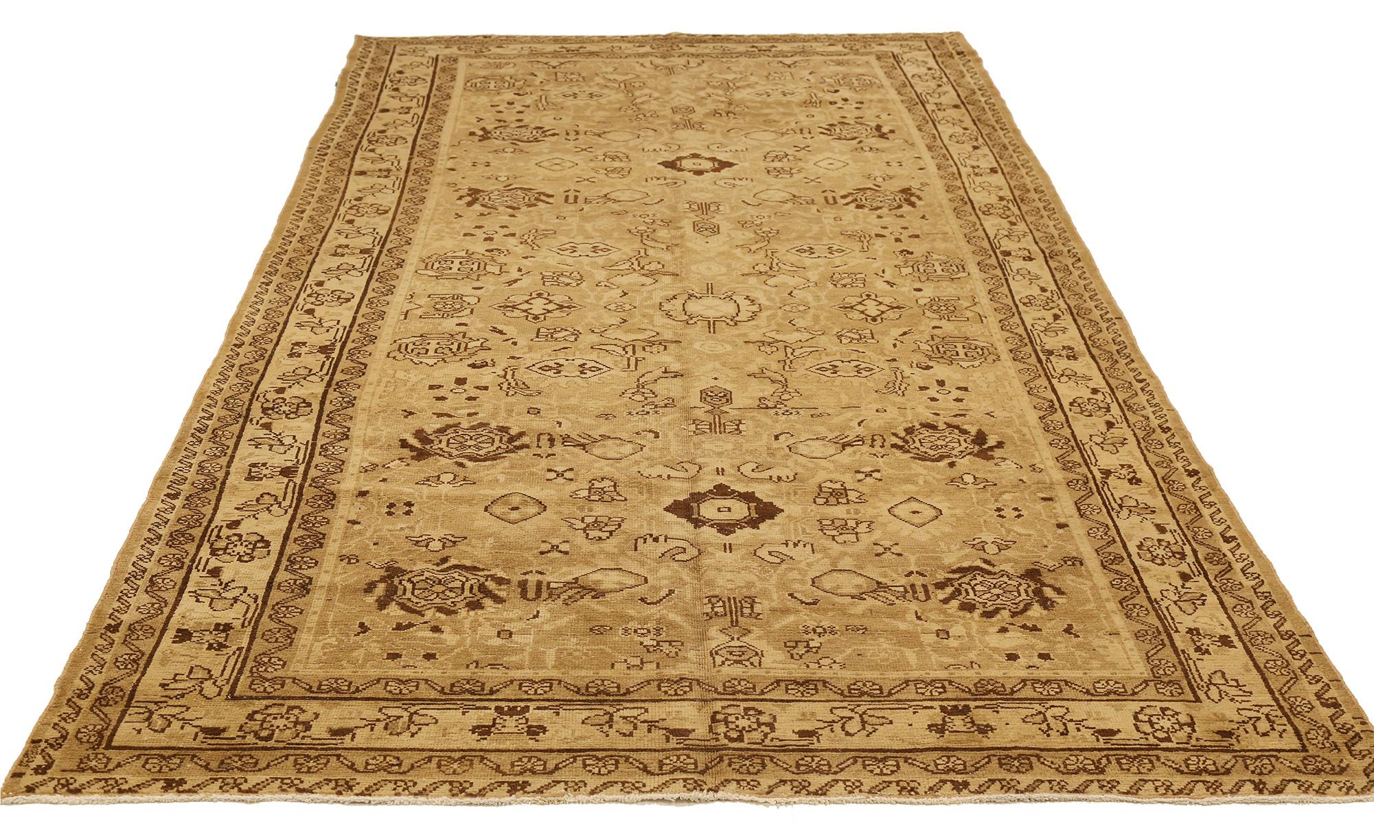 Antique Persian rug handwoven from the finest sheep’s wool and colored with all-natural vegetable dyes that are safe for humans and pets. It’s a traditional Malayer design featuring brown floral details all over its beige and ivory field. It’s a