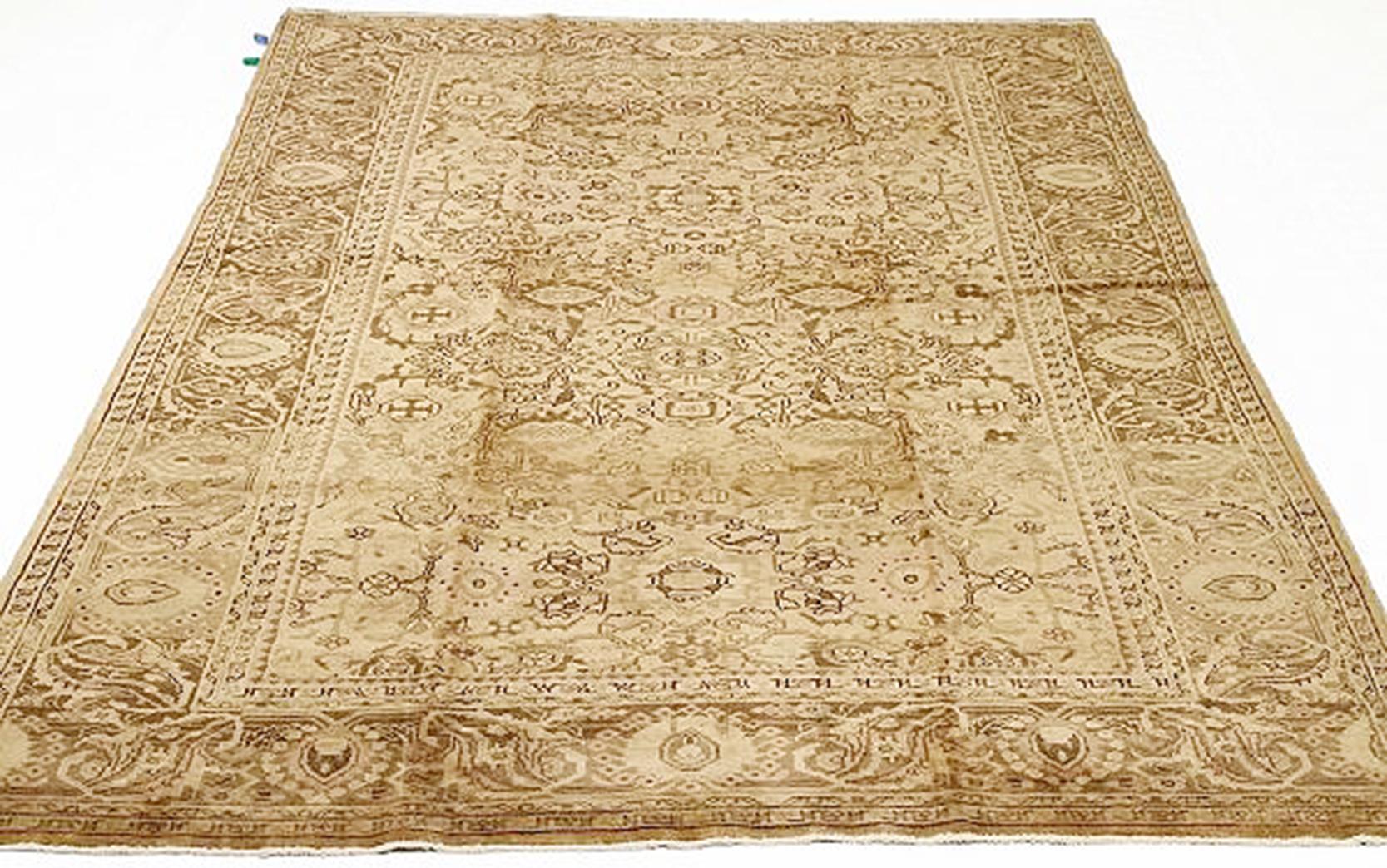 Antique Persian rug handwoven from the finest sheep’s wool and colored with all-natural vegetable dyes that are safe for humans and pets. It’s a traditional Malayer design featuring brown floral and geometric details over a beige field. It’s a