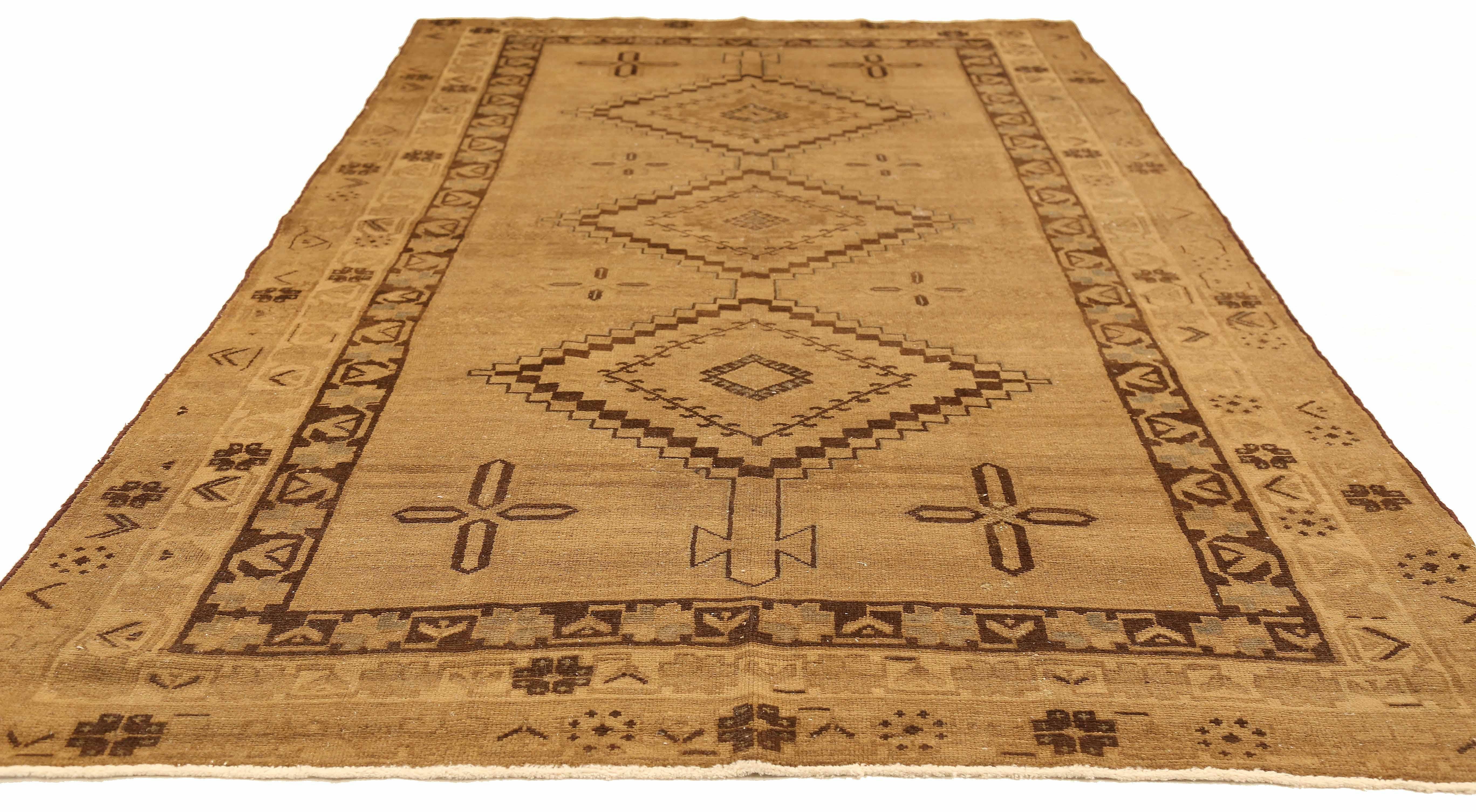 Antique Persian runner rug handwoven from the finest sheep’s wool and colored with all-natural vegetable dyes that are safe for humans and pets. It’s a traditional Malayer design featuring brown geometric details over a beige field. It’s a lovely