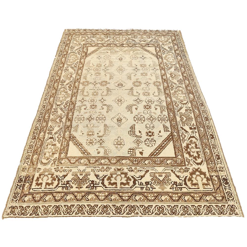 Antique Persian runner rug handwoven from the finest sheep’s wool and colored with all-natural vegetable dyes that are safe for humans and pets. It’s a traditional Malayer design featuring brown and gray tribal details over an ivory field. It’s a