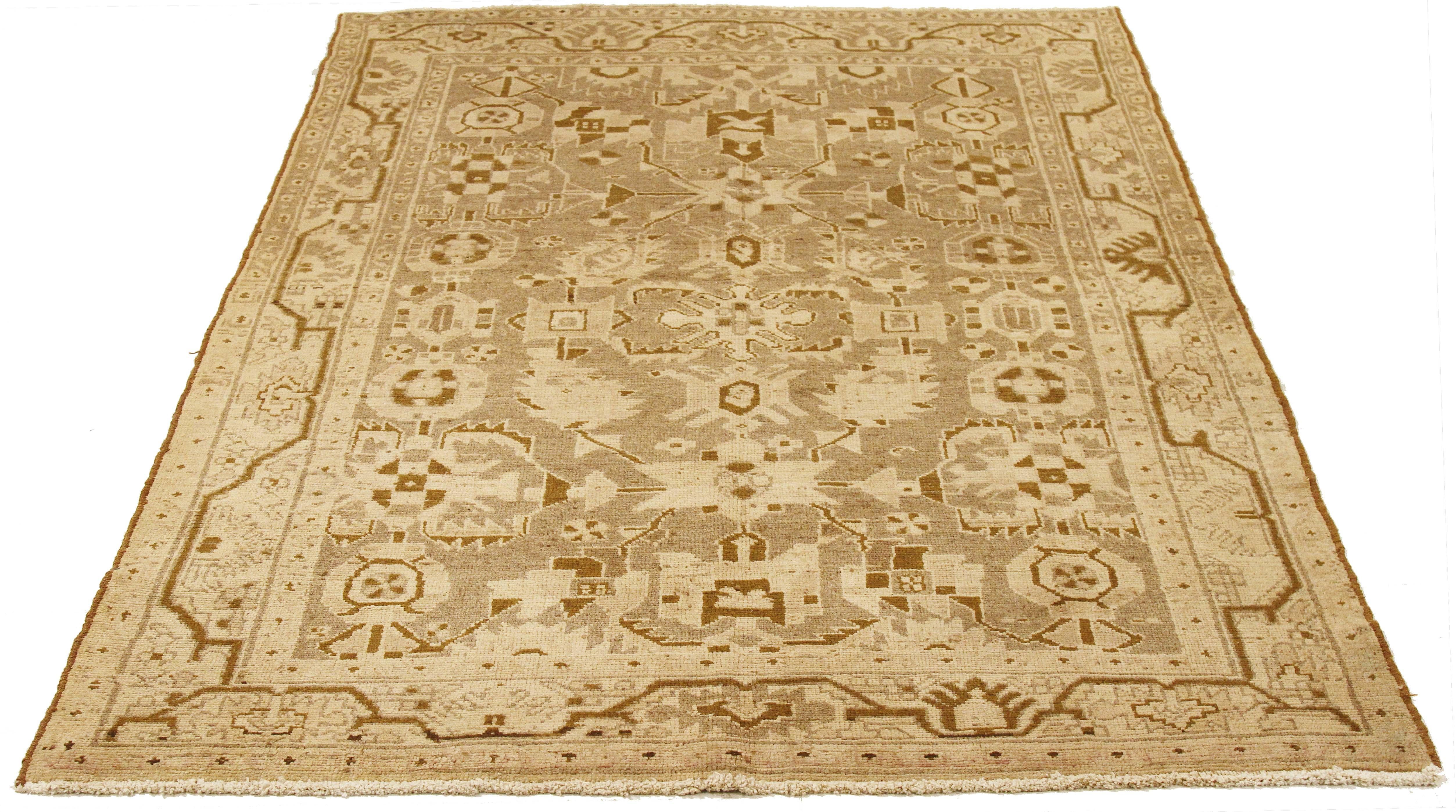 Antique Persian rug handwoven from the finest sheep’s wool and colored with all-natural vegetable dyes that are safe for humans and pets. It’s a traditional Malayer design featuring brown and ivory geometric details on a beige field. It’s a lovely