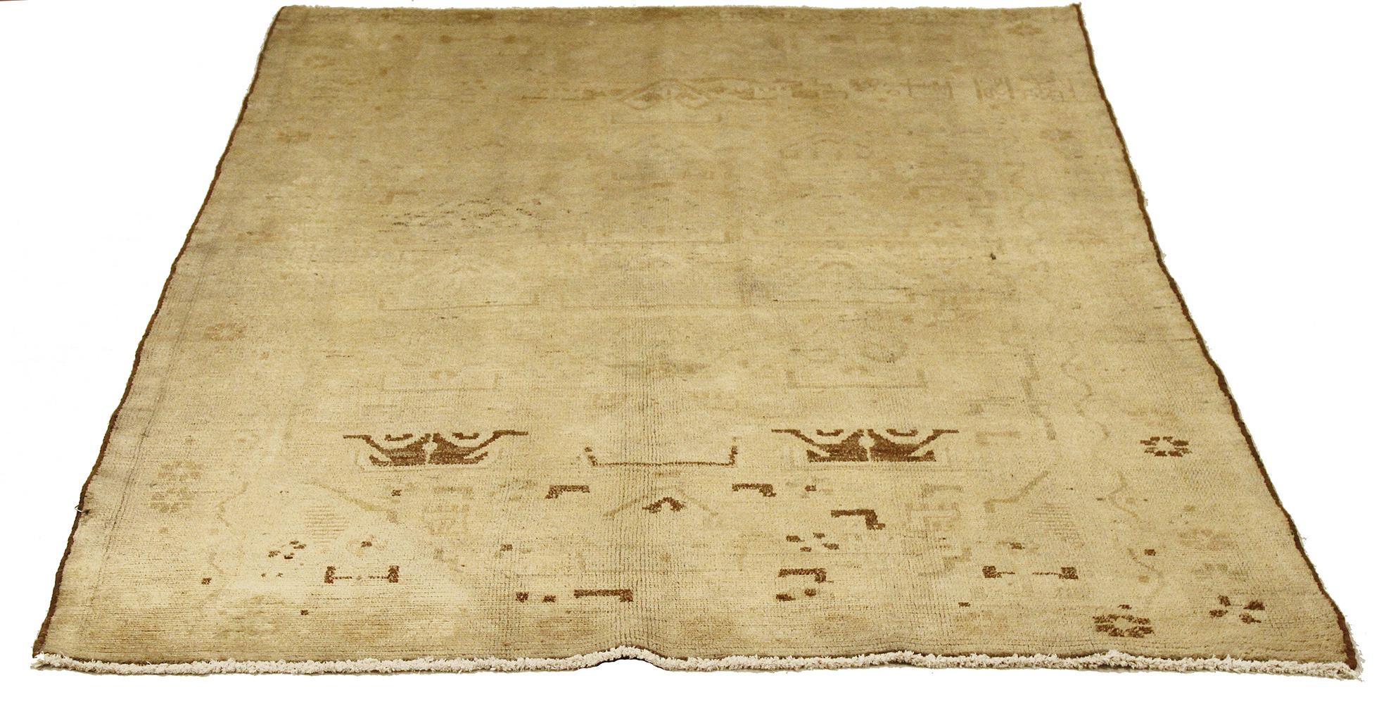 Antique Persian runner rug handwoven from the finest sheep’s wool and colored with all-natural vegetable dyes that are safe for humans and pets. It’s a traditional Malayer design featuring faded brown botanical details over an ivory field. It’s a