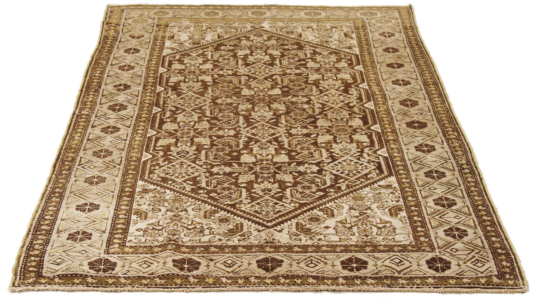 Antique Persian rug handwoven from the finest sheep’s wool and colored with all-natural vegetable dyes that are safe for humans and pets. It’s a traditional Malayer design featuring a mix of floral and geometric details in beige and brown on an