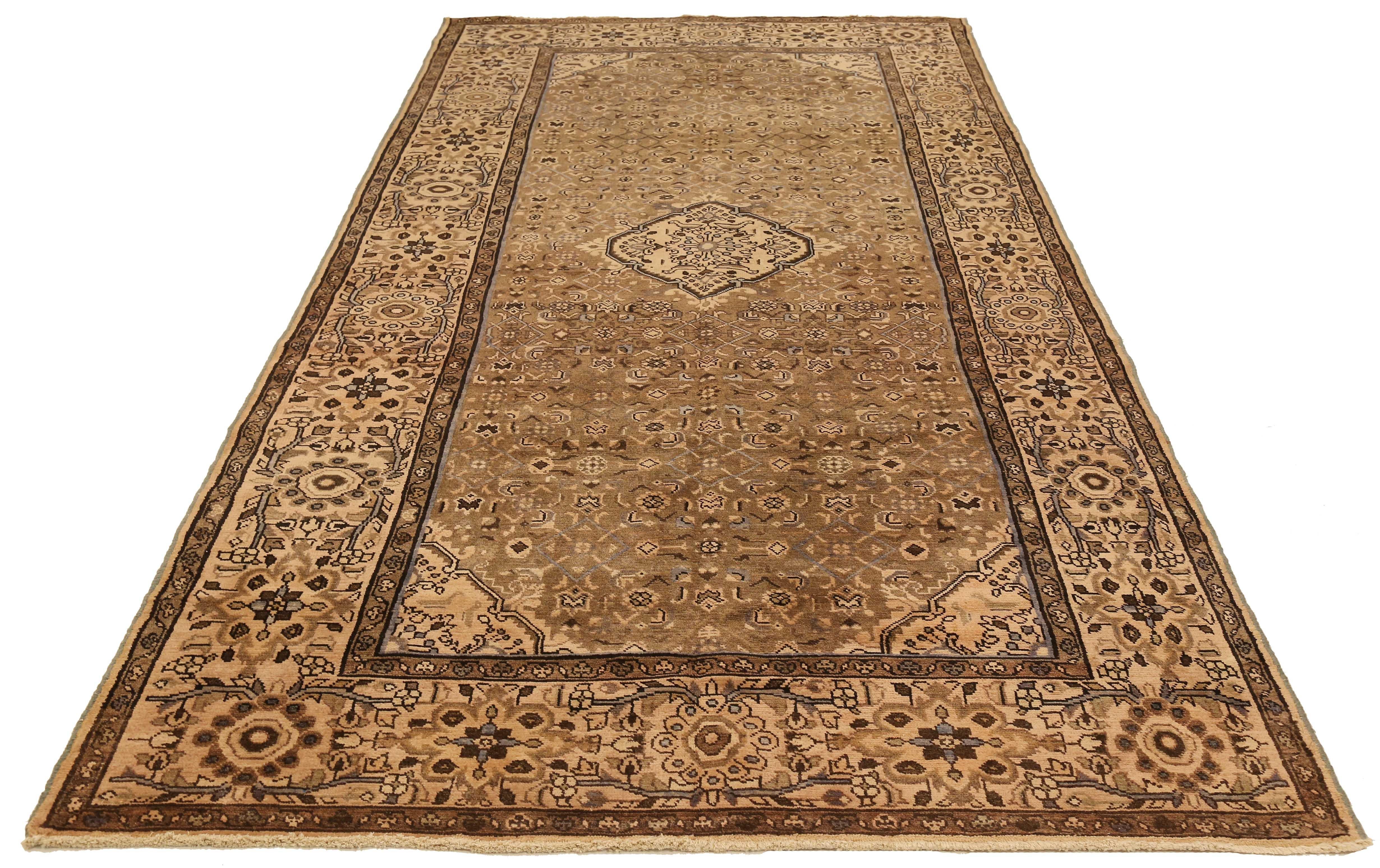 Antique Persian runner rug handwoven from the finest sheep’s wool and colored with all-natural vegetable dyes that are safe for humans and pets. It’s a traditional Malayer design featuring gray and brown botanical details over an ivory-beige field.