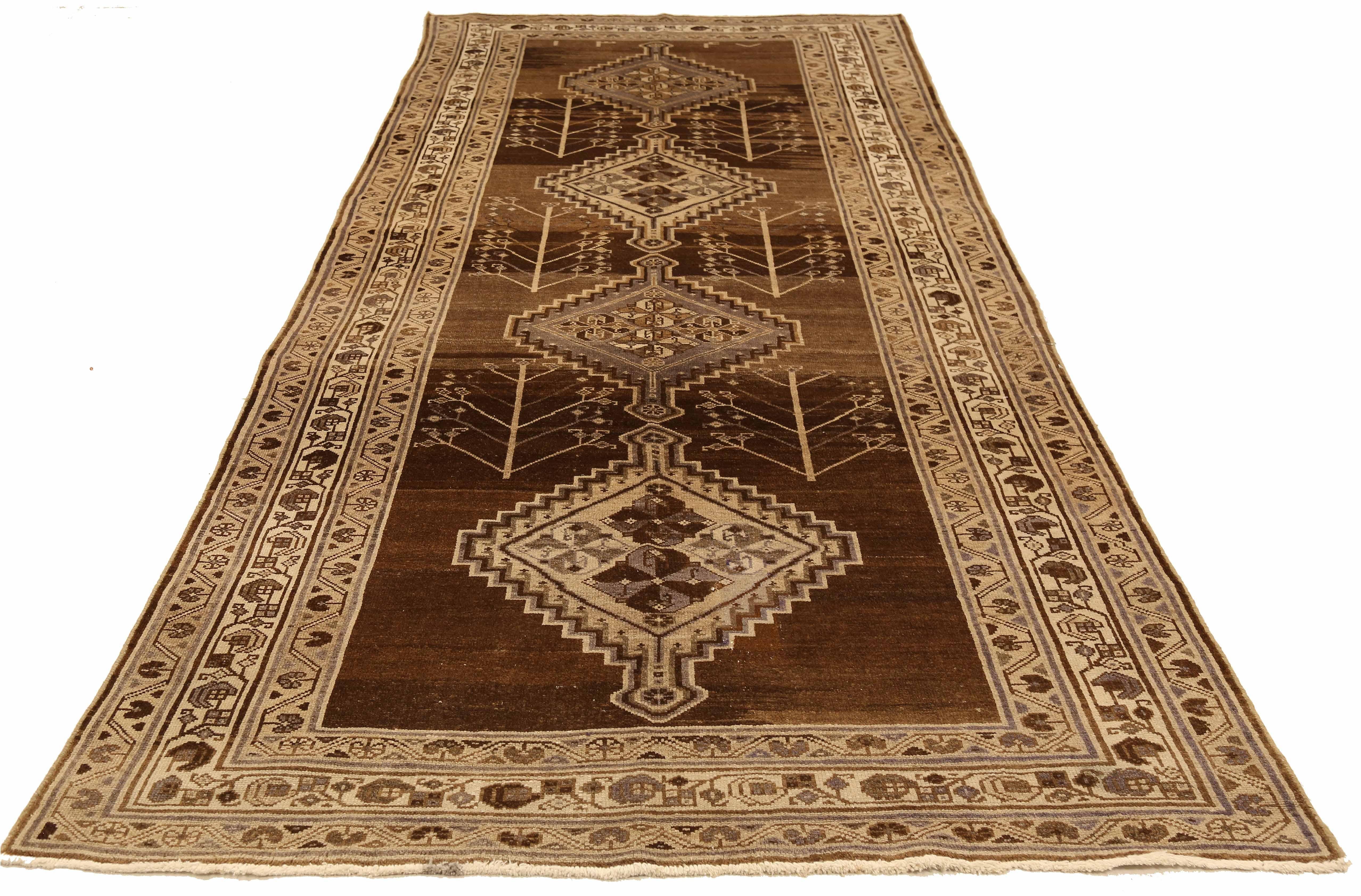 Antique Persian runner rug handwoven from the finest sheep’s wool and colored with all-natural vegetable dyes that are safe for humans and pets. It’s a traditional Malayer design featuring gray and brown diamond medallion details over an ivory-beige